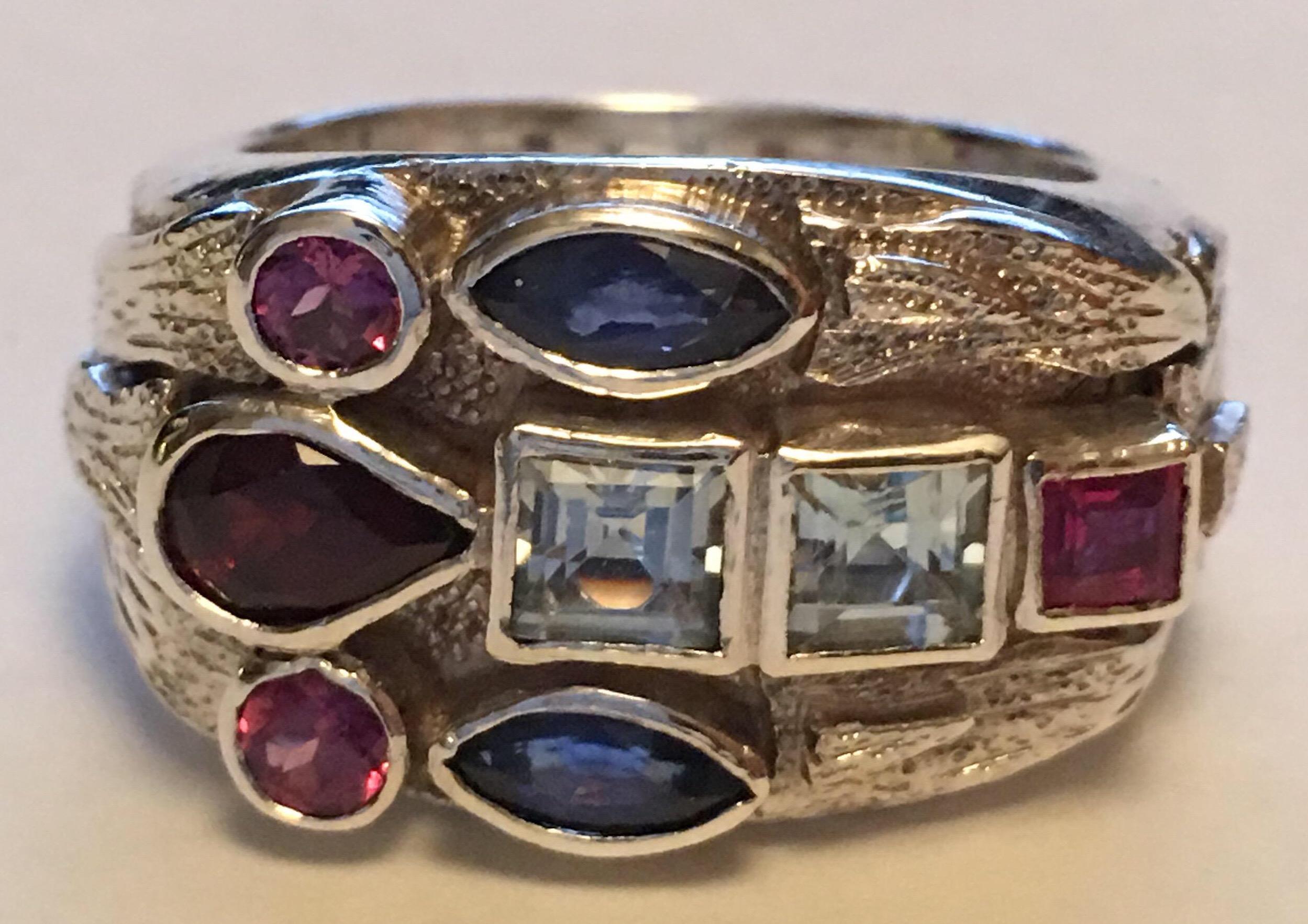 Marquise Blue sapphire, Square ruby, Round Tourmaline, square aquamarine and Pears shape Garnet set in sterling silver.
One of a kind hand crafted ring.
All the stones are natural , hand cut and polished.
Size of the ring is 8 but can be