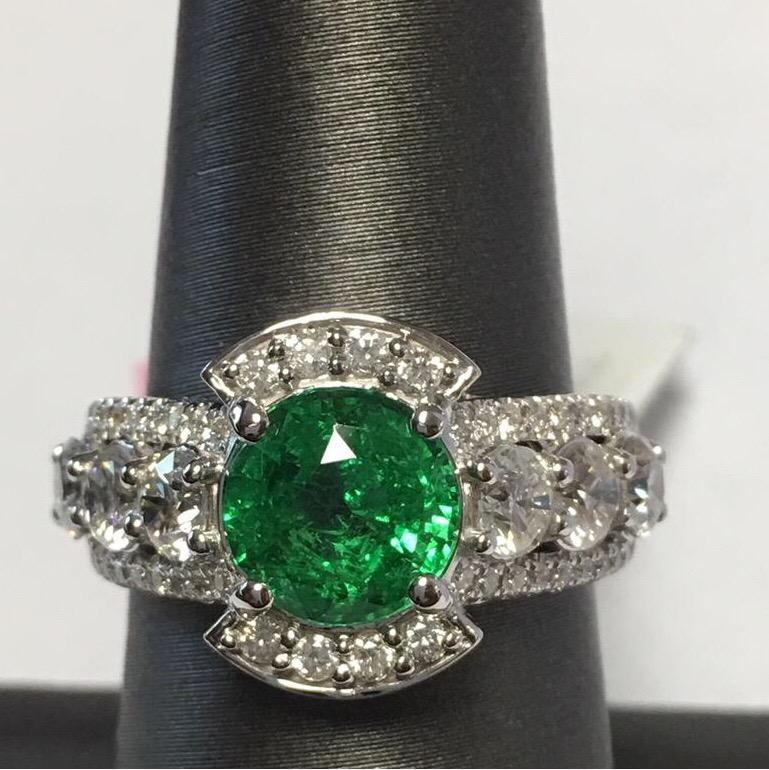 Green Garnet Tsavorite is rare to find bigger than 2 Carat. This ring has round 2.30 Carat tsavorite and  1.79 Carat white VS 2 diamond with F Color set in 14K White gold. Size of the ring is 7 but can be resized.