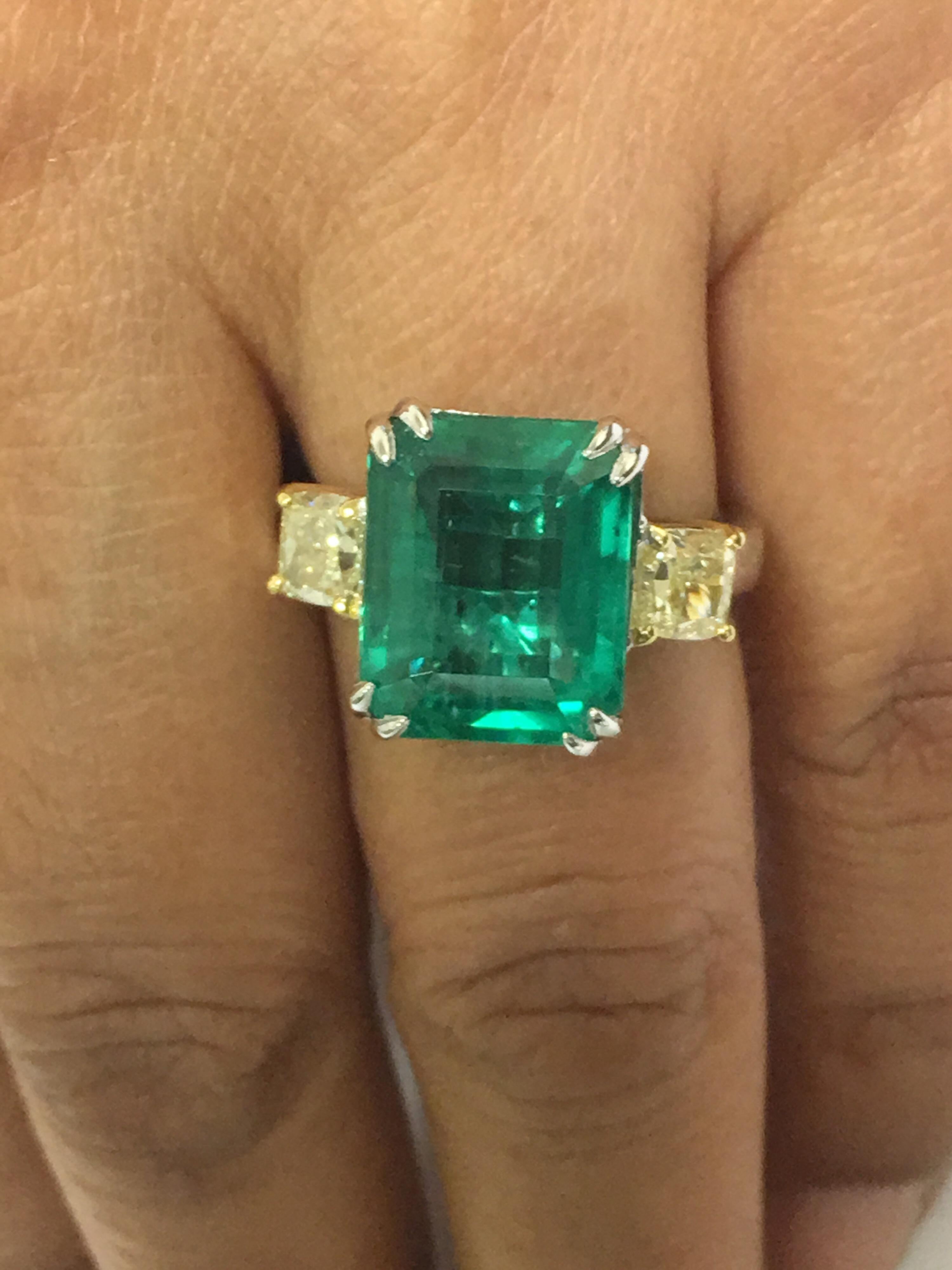 Natural Emerald with two yellow diamonds set in 18 Karat two tone gold. Size of the rectangular Emerald is 8.17 Carat and two Yellow Diamond 1.10 Carat.Emerald is not enhanced.colored,treated 100% natural with very less Inclusion. The Size of the