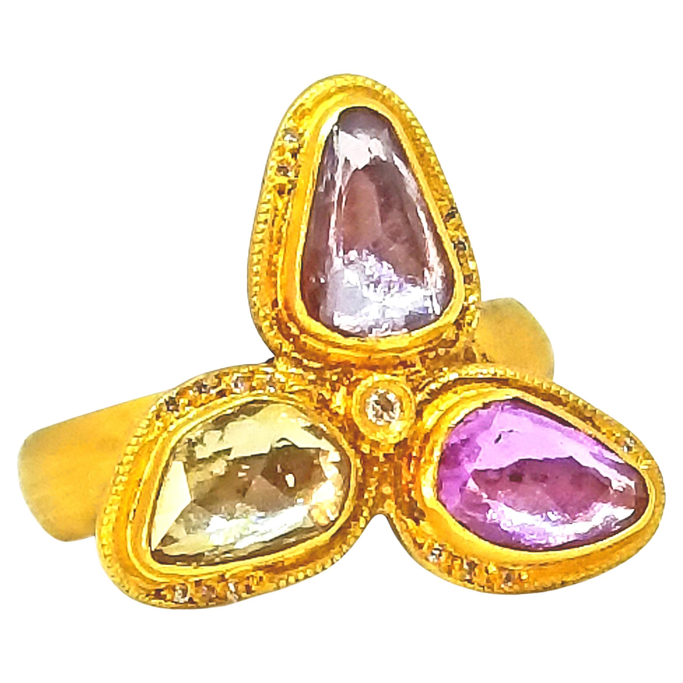 One entirely Hand Crafted Ring made in Turkey by the Husband and Wife Team at Kurtulan, Naci and Meltem. The Ring features three Rose Cut, Pastel Sapphires of 2.72 Carats total weight set in bezels and a small Round Diamond in the center of 0.04