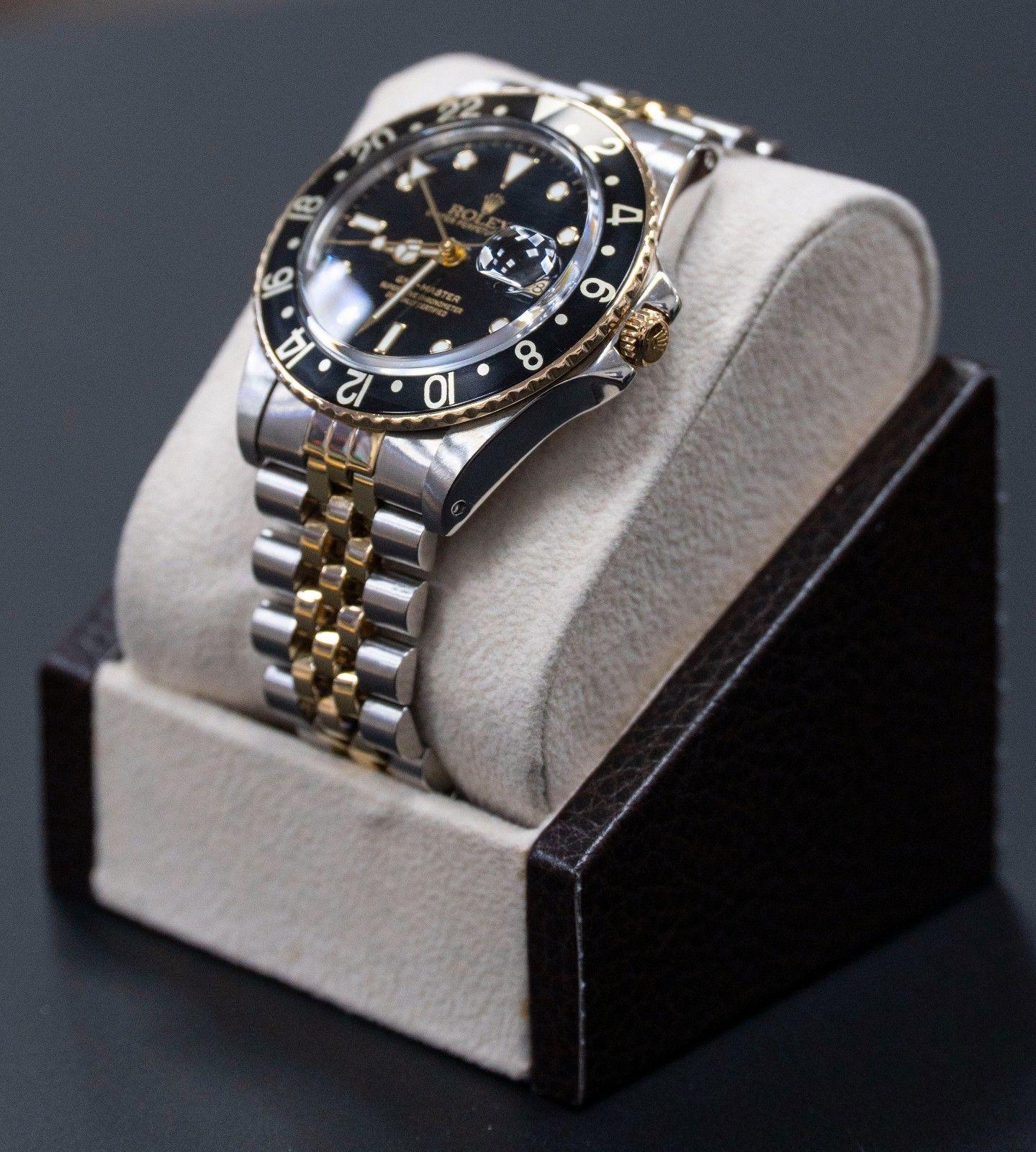 Style Number: 16753
Serial: 6295***
Model: GMT Master
Case: Stainless Steel
Band: 18K Yellow Gold & Stainless Steel 
Bezel: Black
Dial: Black
Face: Acrylic 
Case Size: 40mm
Includes: 
-Elegant Watch Box
-Certified Appraisal 
-6 Month Warranty