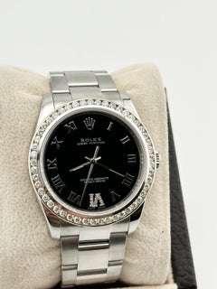 Rolex Oyster Perpetual 114200 34mm Black Roman Dial Diamond Bezel Steel