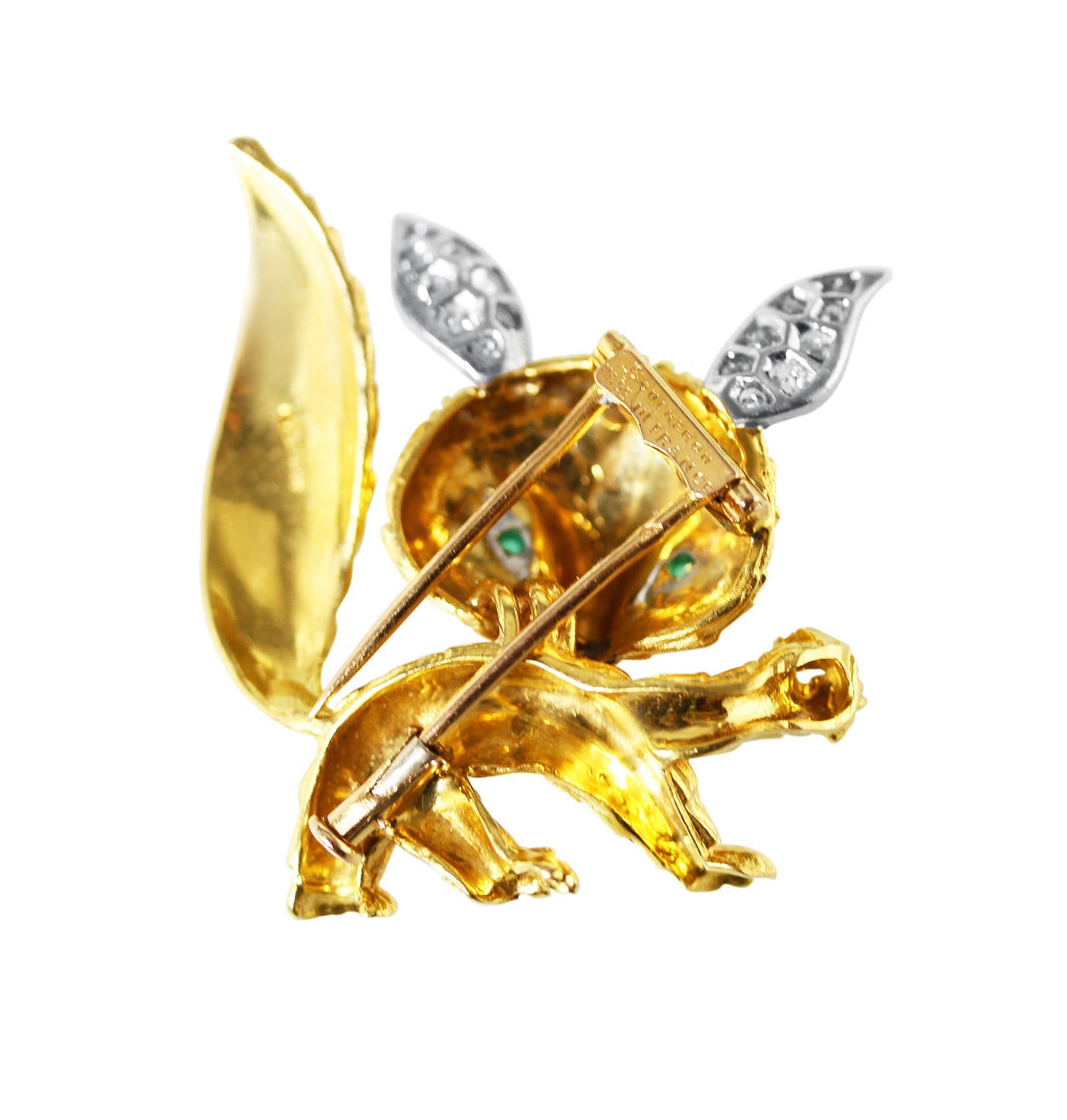 A whimsical 18 karat yellow and white gold, diamond and emerald fox pin by Boucheron, France, the fox with cabochon emerald eyes and ears set with 16 round diamonds weighing approximately 0.35 carat, gross weight 13.8 grams, signed Boucheron, Made