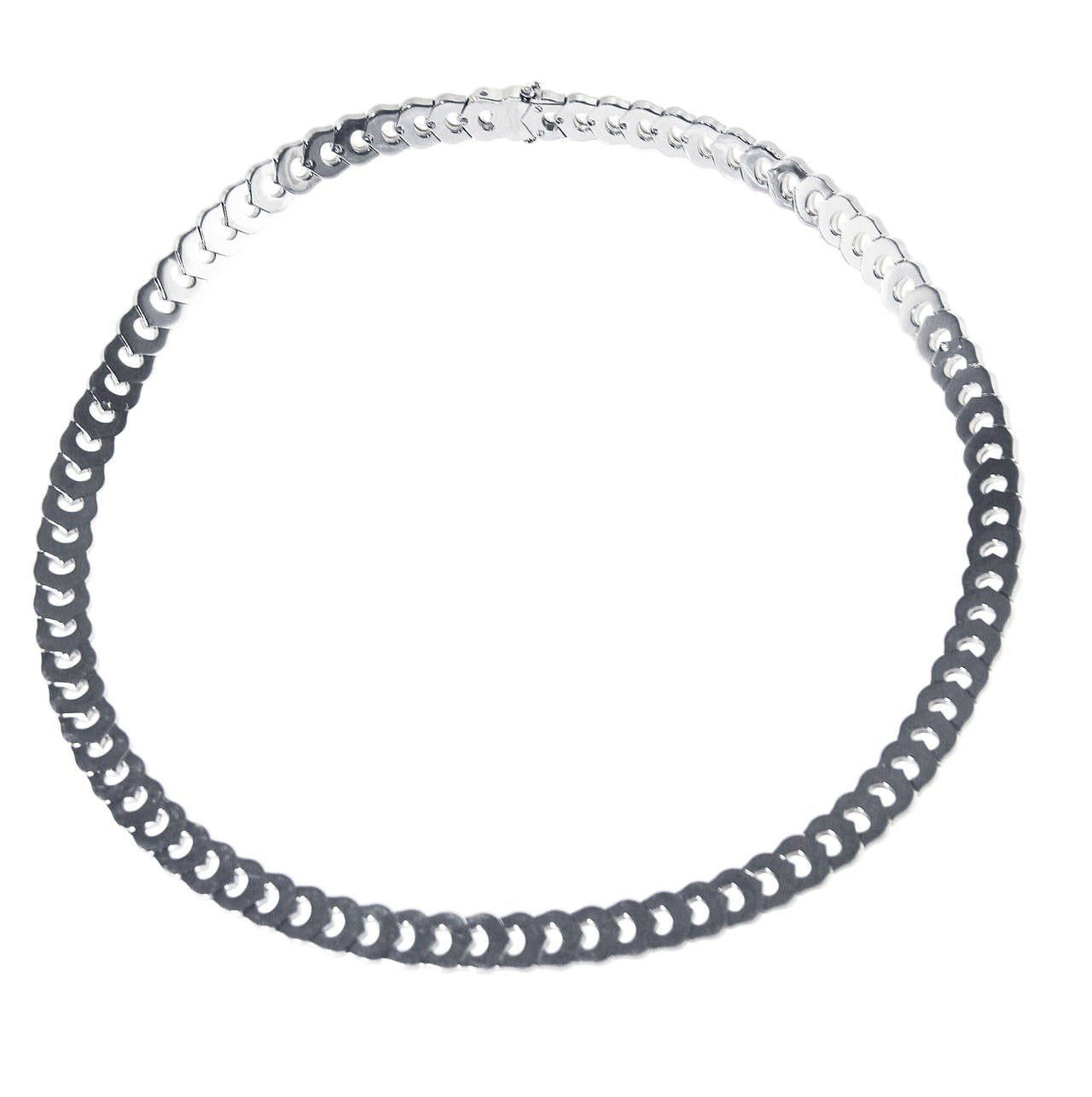An 18 karat white gold 'C' necklace by Cartier, France, designed as repeating links of white gold C's, length 16 inches, width 3/8 inch, gross weight 89.9 grams, signed Cartier, numbered 881189, stamped 750, French assay and workshop marks. 