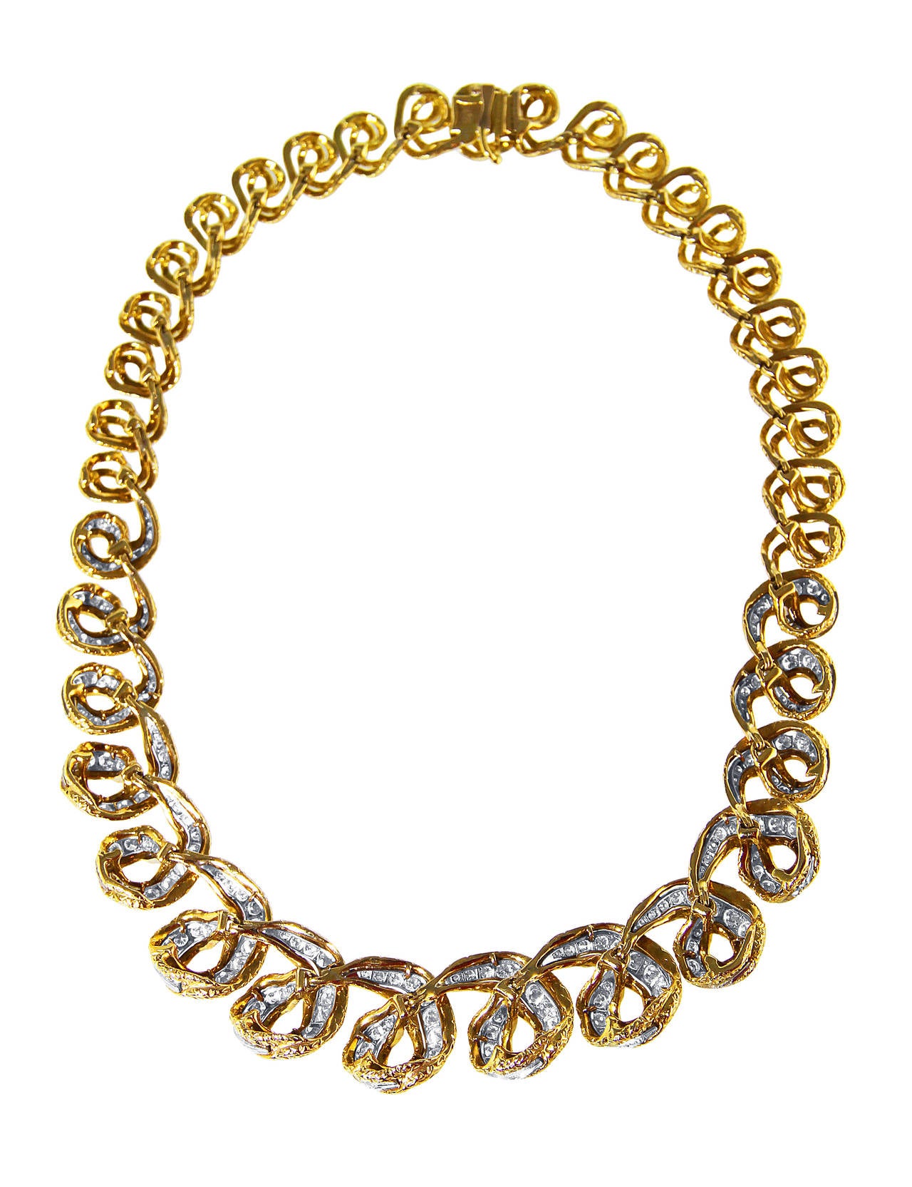 An 18 karat yellow gold, platinum and diamond necklace, France, of tapered design composed of stylized circular links set at the front with 220 round diamonds weighing approximately 10.00 carats, gross weight 103.4 grams, length 15 3/4 inches, width