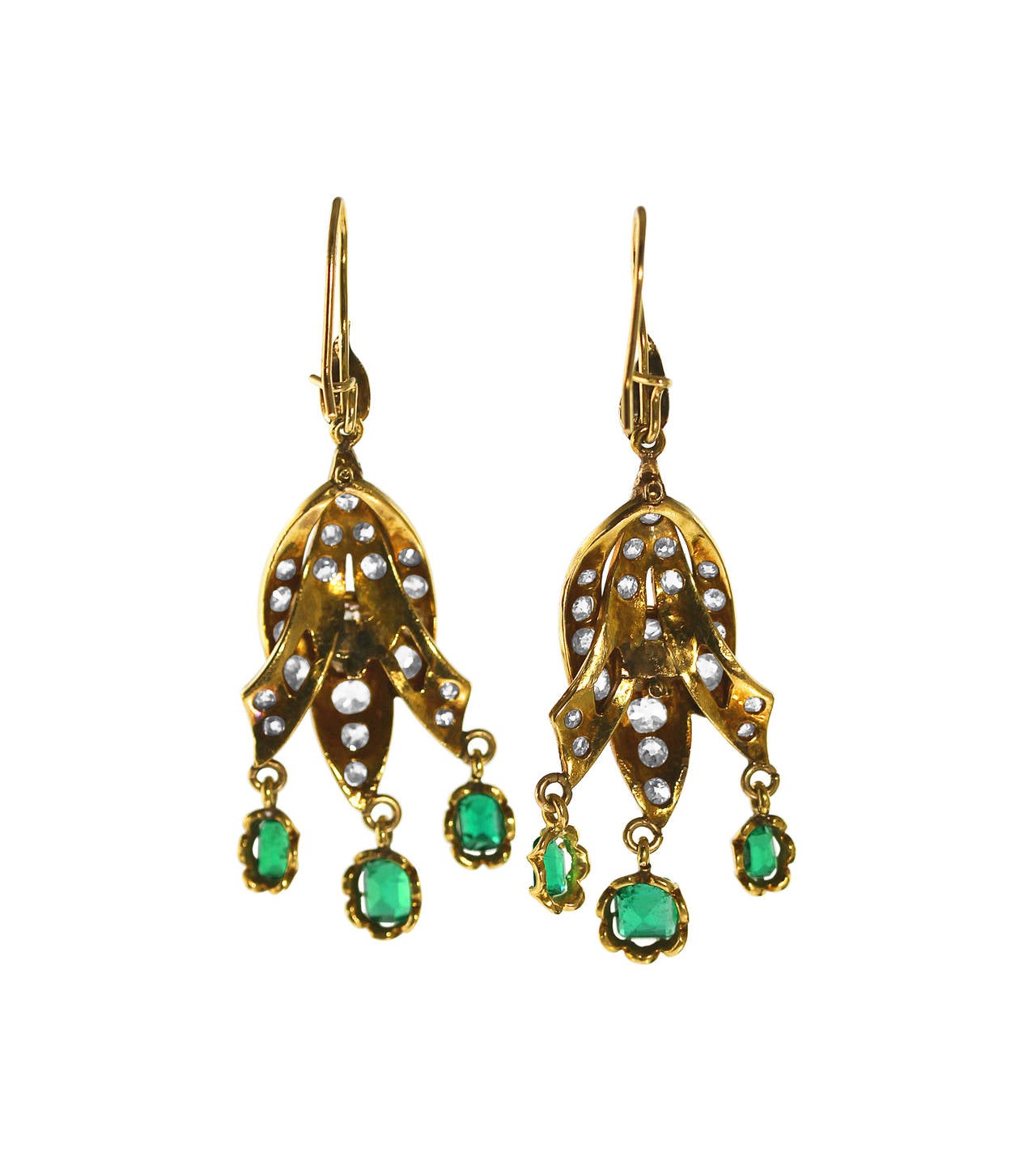 A pair of antique 14 karat yellow gold, emerald and diamond pendant earrings, designed ornate gold plaques set with 44 old mine-cut diamonds weighing approximately 1.80 carats, supporting articulated pendants set with 6 emerald-cut emeralds weighing