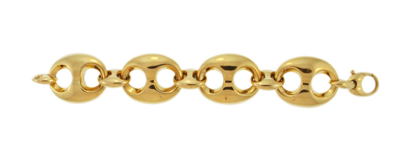 An 18 karat yellow gold link bracelet by Gucci, designed as a series of stylized openwork oval links, gross weigth 76.3 grams, length 6 1/2 inches, width 1 1/4 inches, signed Gucci.  A stylish chunky gold bracelet great for any occasion.