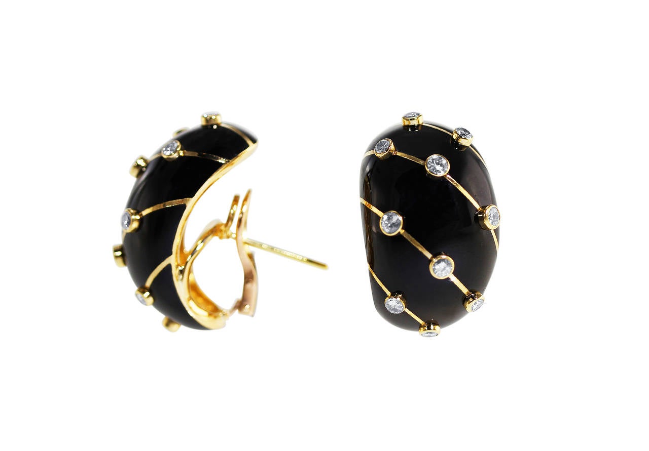 A pair of 18 karat yellow gold, diamond and black enamel earrings by Schlumberger for Tiffany & Co., composed of applied paillonne black colored enamel, accented by round diamonds weighing approximately 1.75 carats, length 1 1/4 inches, width 3/4