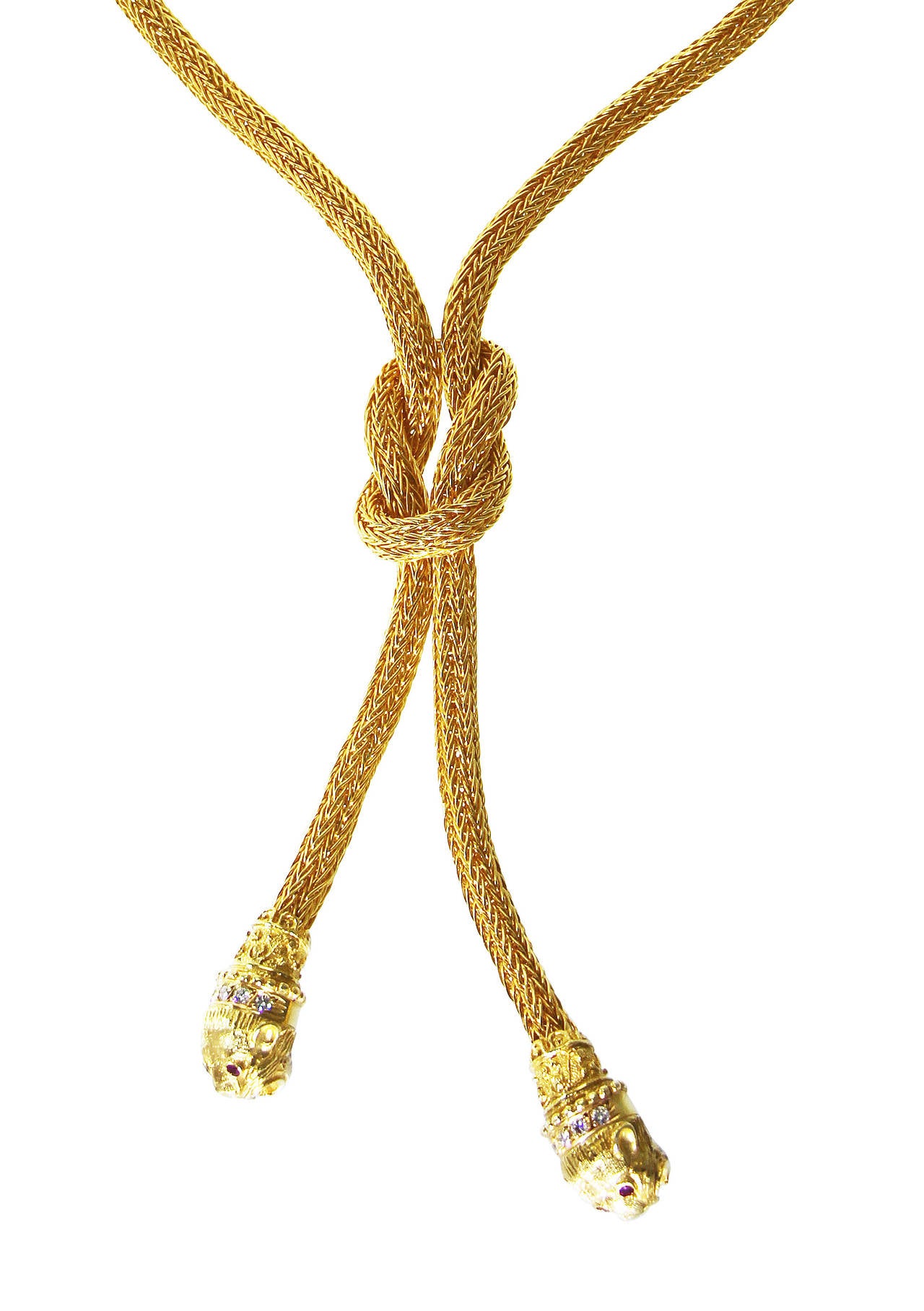 An 18 karat gold and diamond lion's head necklace by Lalaounis, Greece, the lariat style necklace composed of woven gold strands knotted at the center, the ends supporting lion's heads set with 10 round diamonds weighing approximately 0.60 carat,