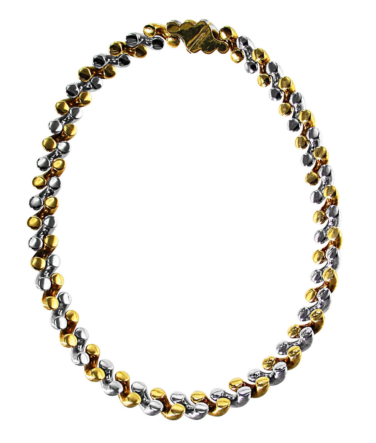 An 18 karat white and yellow gold Torchon Necklace by Buccellati, Italy, designed as diagonal brushed gold links of alternating white and yellow gold, gross weight 86.4 grams, length 16 inches, width 1/2 inch, signed M. Buccellati, Italy. This