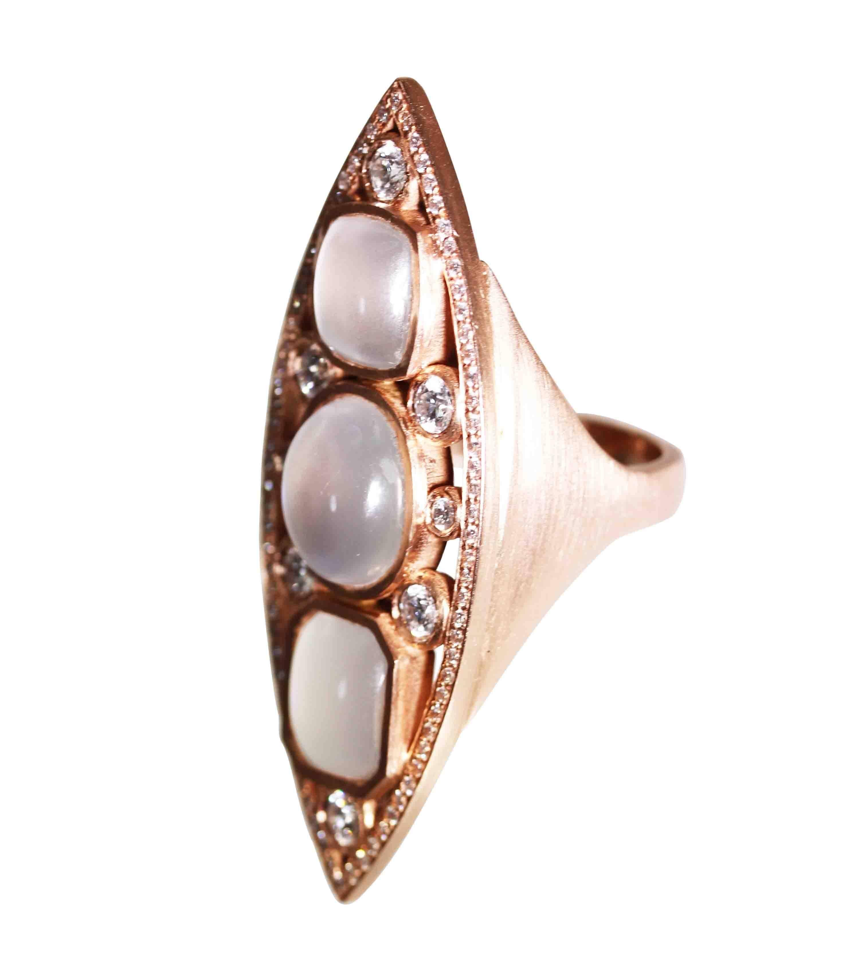 An 18 karat rose gold, moonstone and diamond navette ring, the oblong front set with 3 cabochon moonstones, accented by 6 larger round diamonds weighing approximately 1.00 carat, and 84 round diamonds weighing approximately 1.10 carats, gross weight