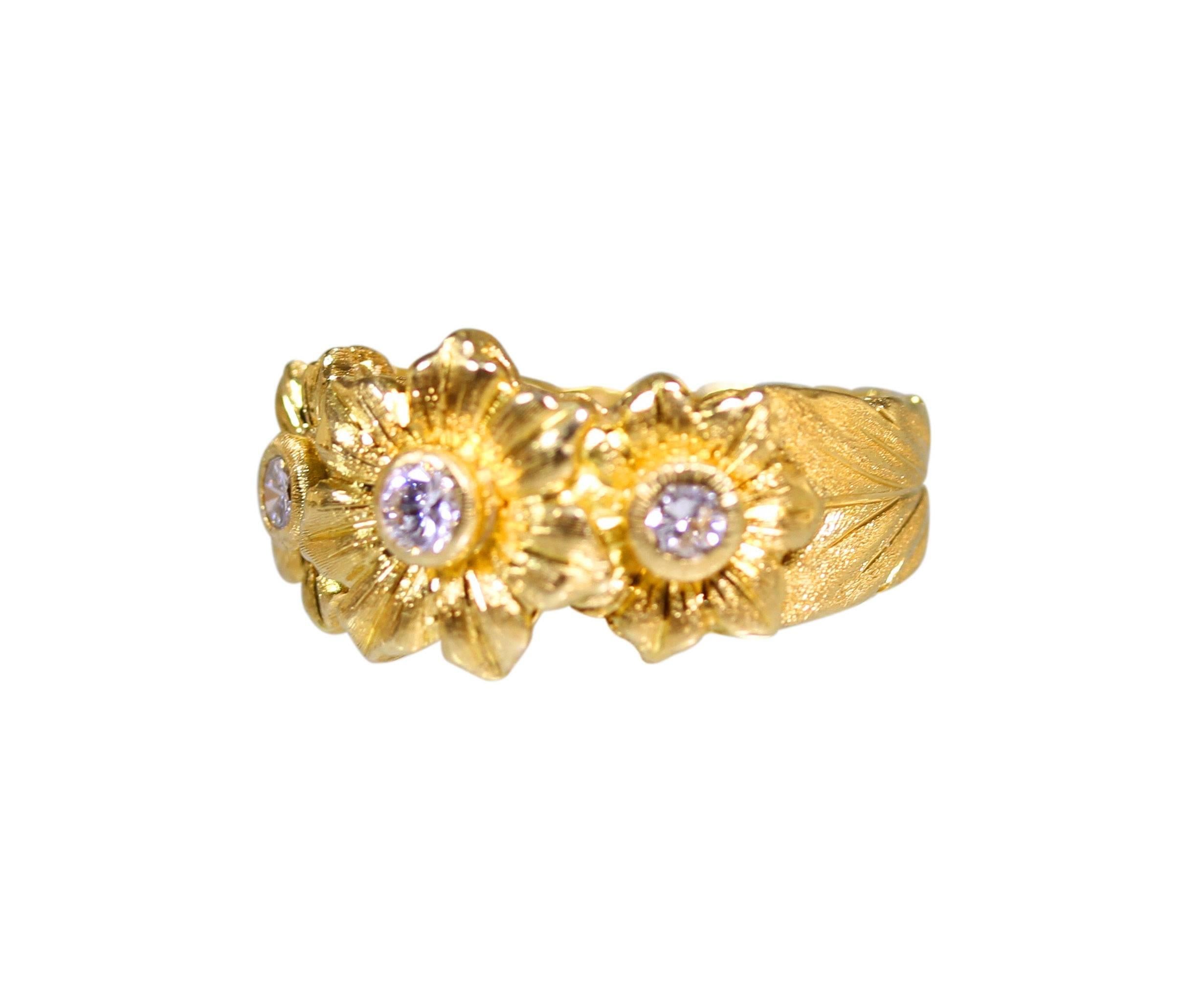 An 18 karat yellow gold and diamond ring by Buccellati, Italy, of floral design composed of three flowers set with 3 round diamonds weighing approximately 0.35 carat, gross weight 8.1 grams, measuring 7/16 by 13/16 by 7/8 inch, size 7, signed Fed.