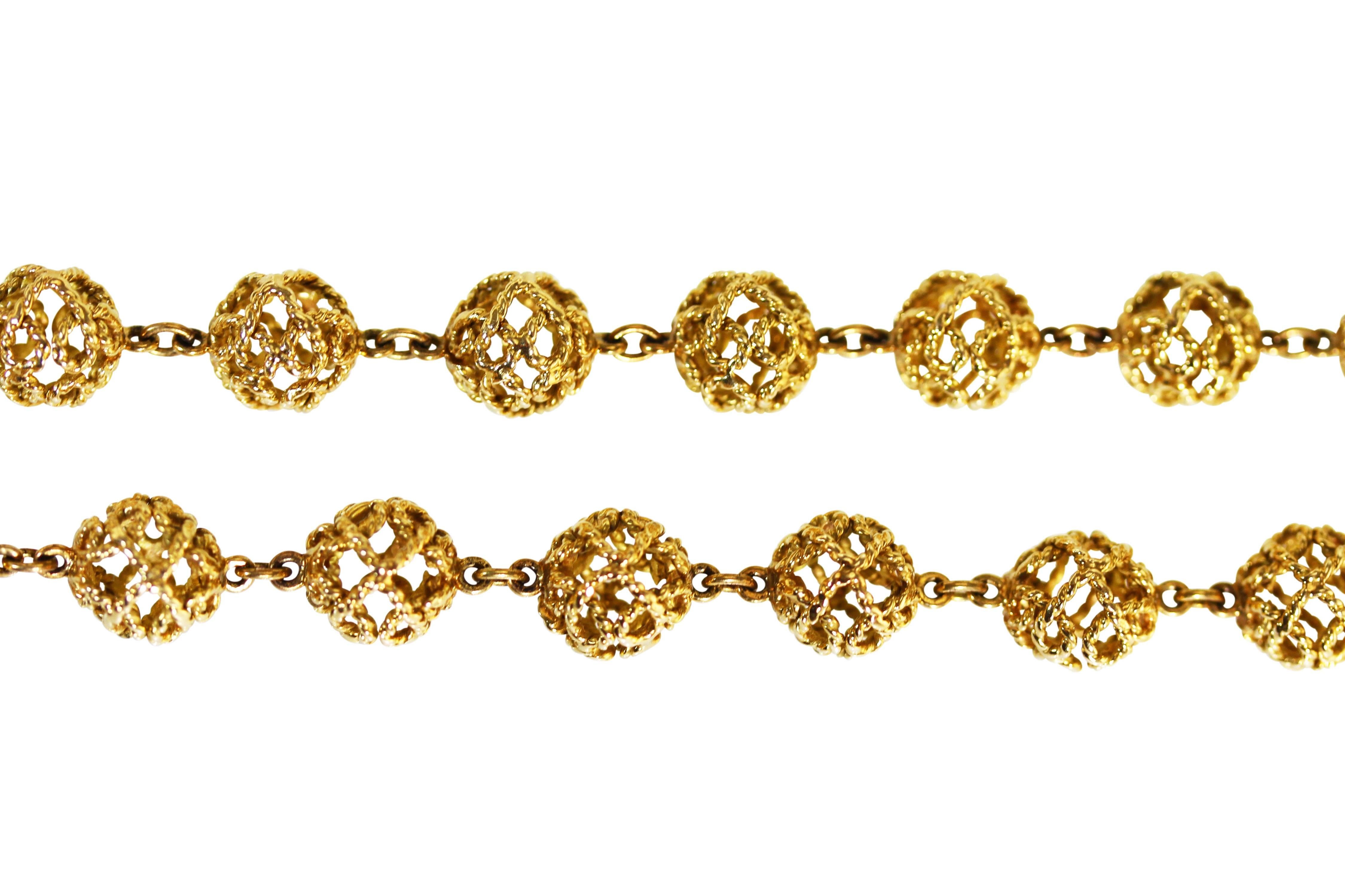 18 karat gold longchain necklace by Van Cleef & Arpels, circa 1960, designed as multiple textured gold spherical beads of open framework design, length 38 1/2 inches, gross weight 81.6 grams, signed VCA ITALY, stamped 18ct.