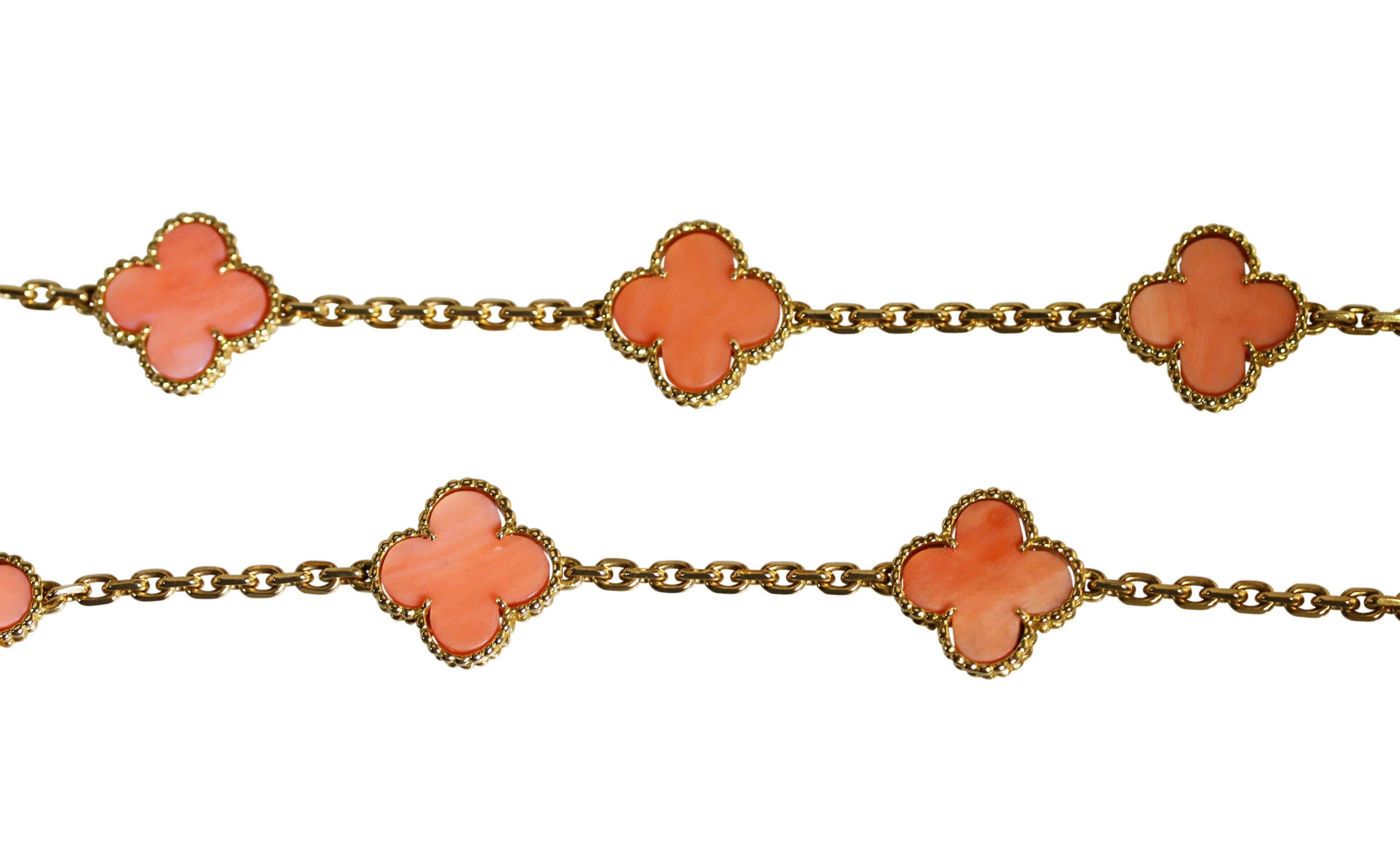 An 18 karat yellow gold and coral 'Alhambra' long chain necklace by Van Cleef & Arpels, France, circa 1993, composed of 20 carved coral motifs spaced by gold links, gross weight 46.5 grams, length 31 3/4 inches, width 5/8 inch, signed VCA, numbered