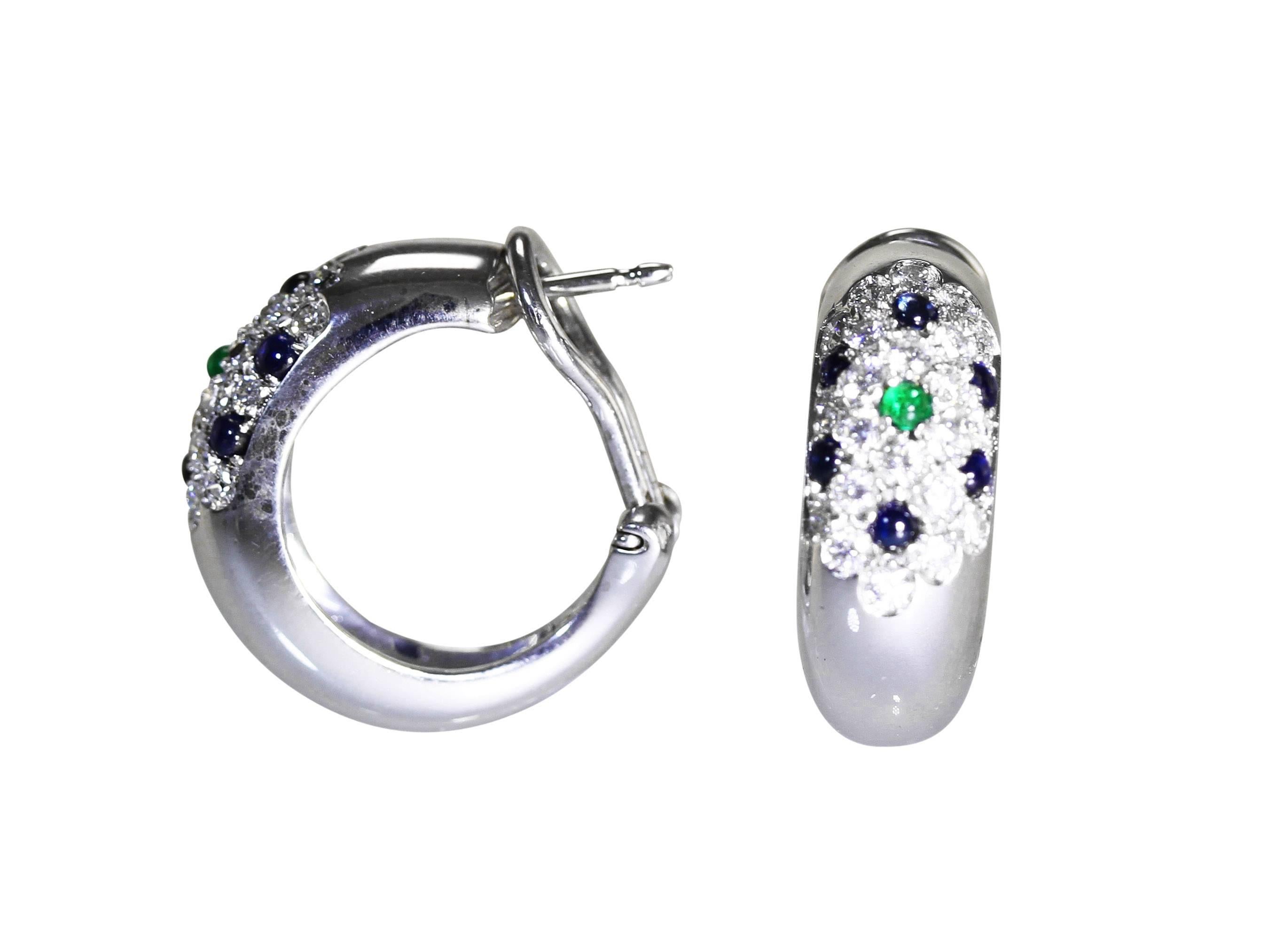 A pair of 18 karat white gold, emerald, sapphire and diamond hoop earclips by Cartier, designed as half hoops pave-set at the tops with 44 round diamonds weighing approximately 1.50 carats, accented by 2 cabochon emeralds weighing approximately 0.20