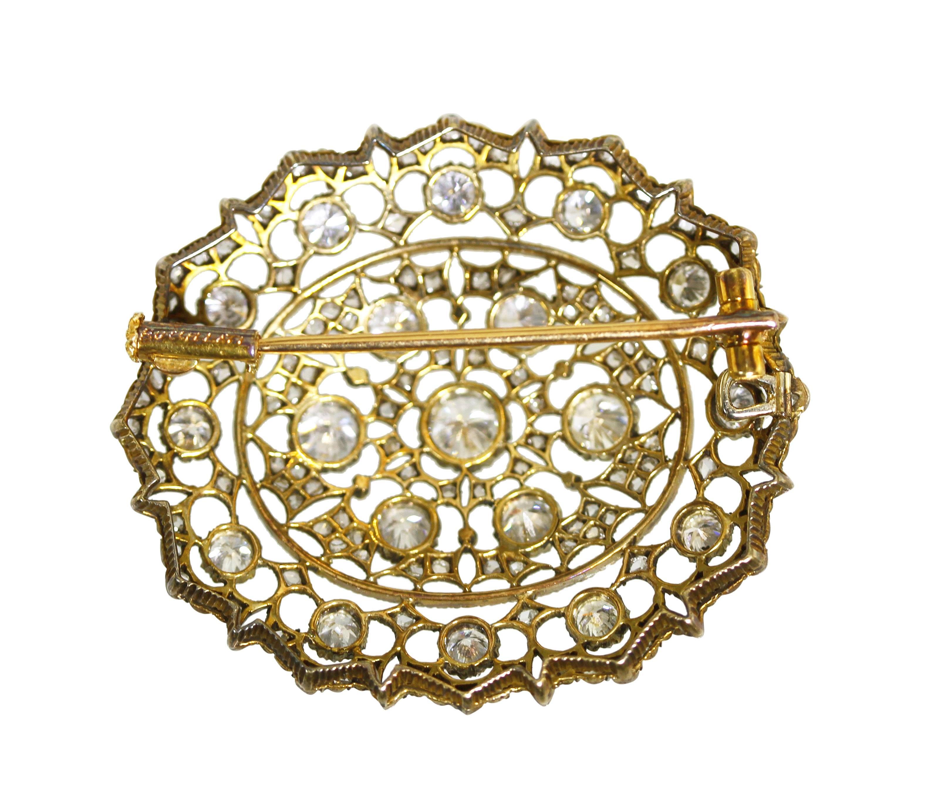 An 18 karat gold, silver and diamond brooch by Mario Buccellati, Italy, circa 1930, of open design set with 19 round diamonds weighing approximately 2.50 carats and 134 rose cut diamonds weighing approximately 1.00 carat, measuring 1 1/2 by 1 3/8