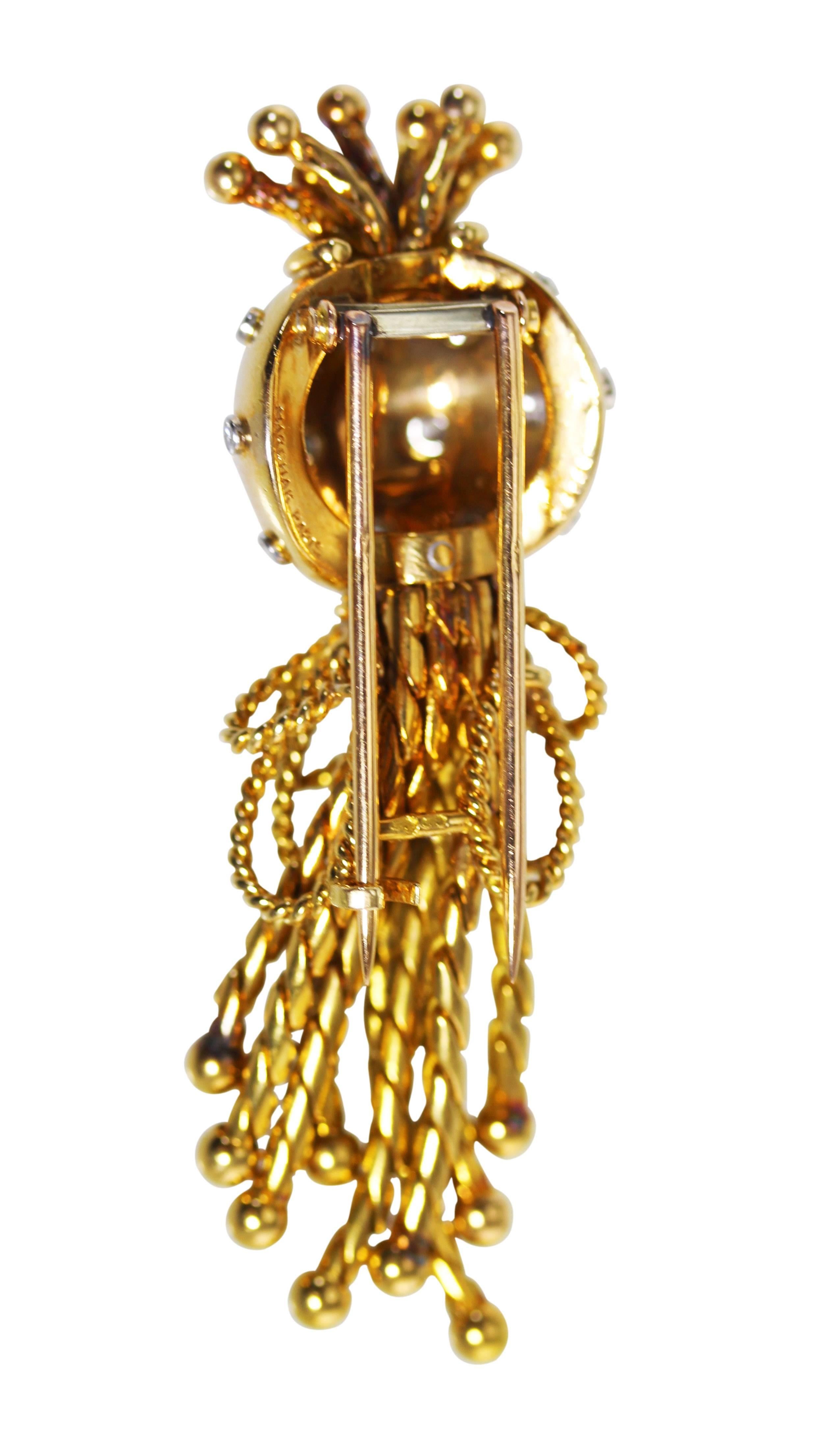 An 18 karat gold and diamond brooch by Marchak, Paris, circa 1940, designed as a dome with 16 bezel-set round diamonds weighing approximately 0.15 carat, suspending nine yellow gold tassels bundled together as fringe, measuring 2 1/4 by 3/4 inches,