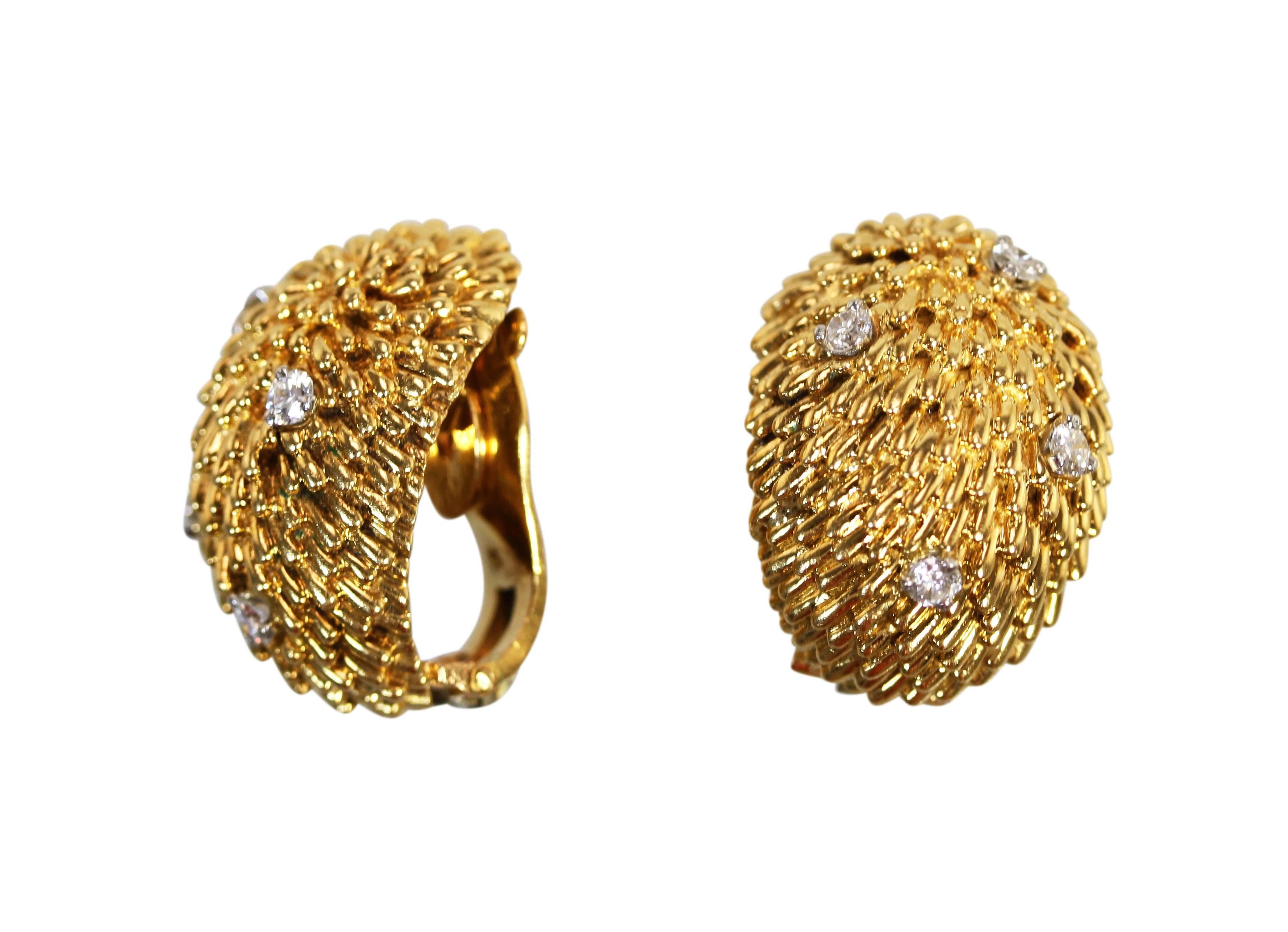 A pair of 18 karat yellow gold and diamond earclips by Van Cleef & Arpels, France, circa 1960, of bombe textured gold design set with 8 round diamonds weighing approximately 0.40 carat, measuring 7/8 by 5/8, gross weight 23.0 grams, signed Van