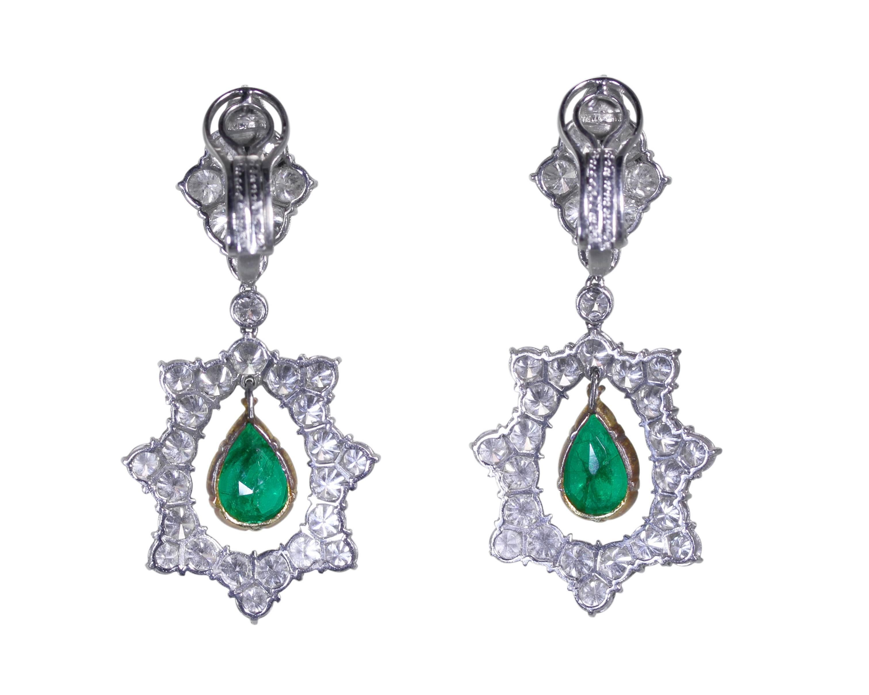 A pair of 18 karat white and yellow gold, emerald and diamond earclips by Buccellati, Italy, suspending 2 pear-shaped emeralds weighing approximately 3.50 carats, in an openwork frame set with 64 round diamonds weighing approximately 11.00 carats,