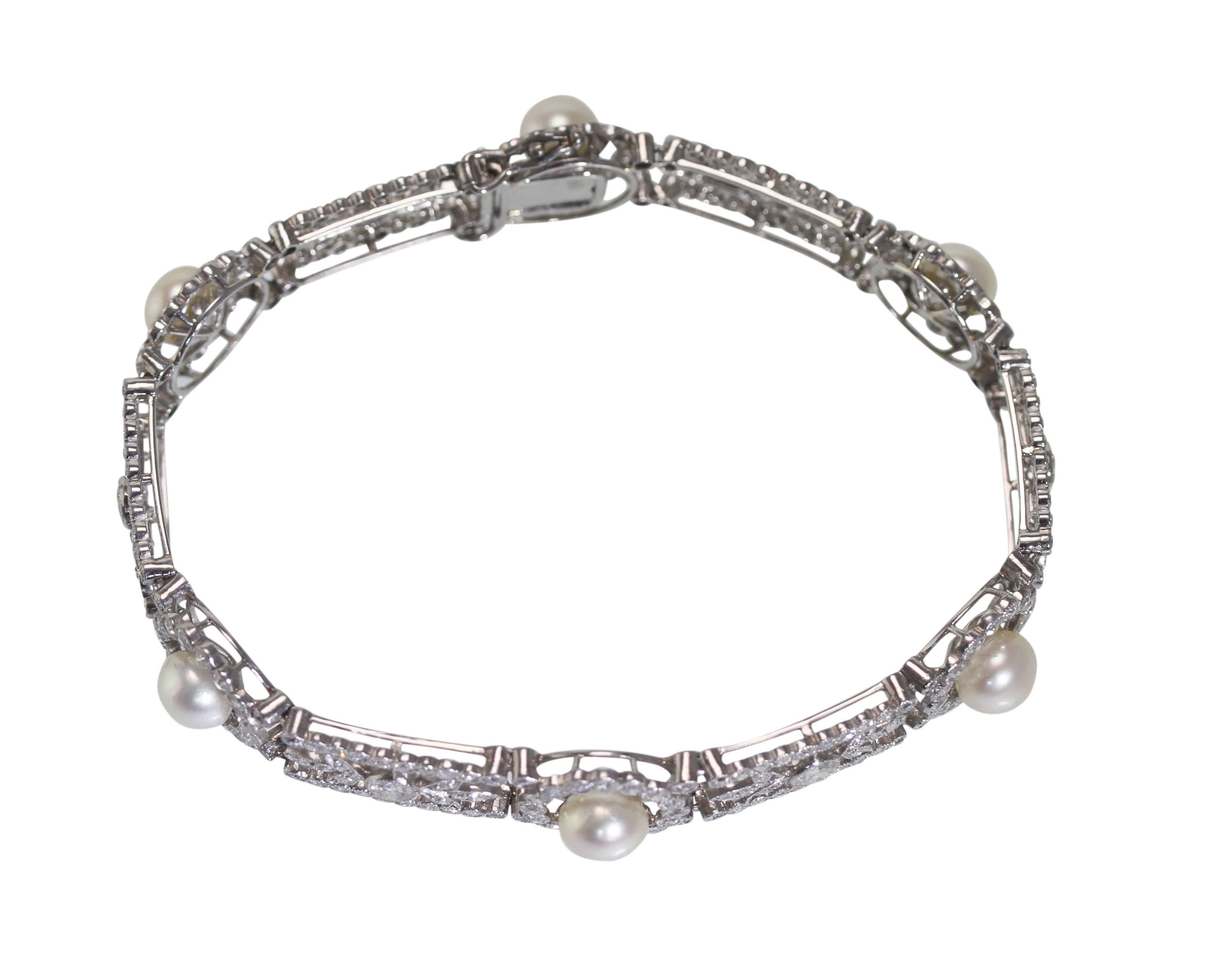 A Belle Epoque platinum, natural pearl and diamond bracelet, France, of openwork foliate design set with 6 natural pearls measuring approximately 6.5 to 6.8 mm., further set throughout 6 old European-cut diamonds weighing approximately 1.25 carats,