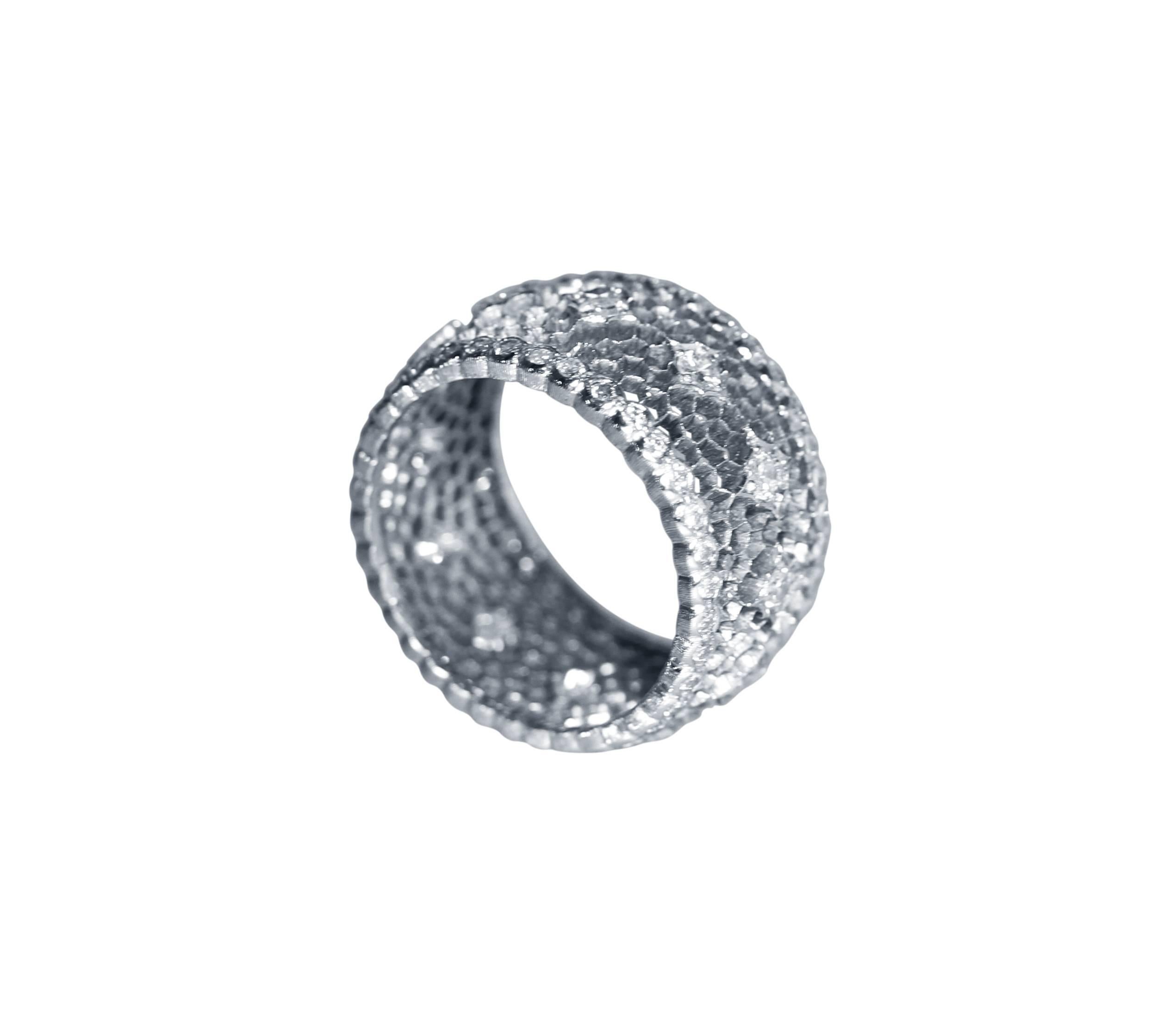 An 18 karat white gold and diamond 'tulle' band ring by Buccellati, Italy, the wide band of openwork design set with 84 round diamonds weighing approximately 1.25 carats, width 3/8 inch, size 5, gross weight 4.5 grams, signed Gianmaria Buccellati,
