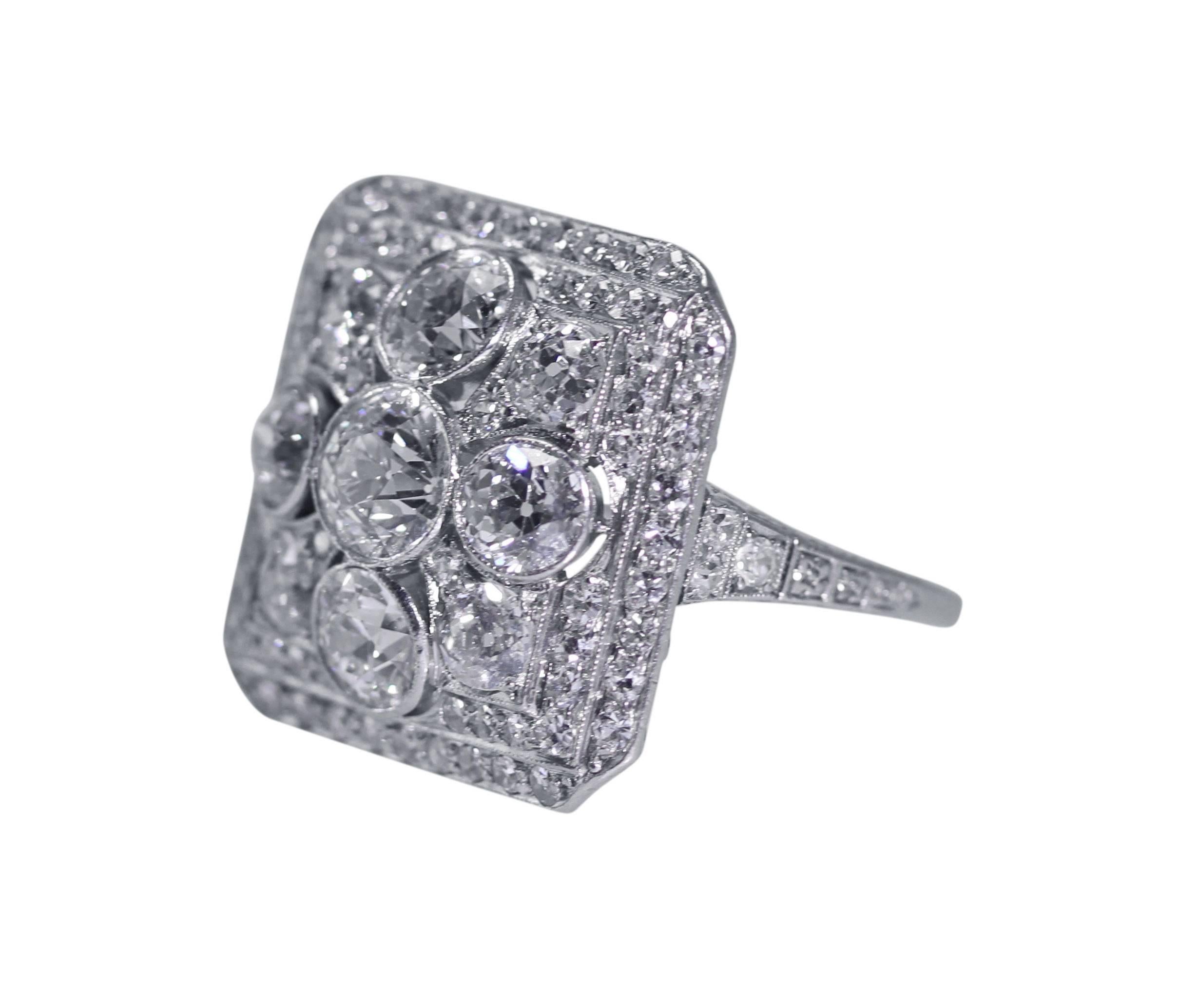An Art Deco platinum and diamond ring by Ellis Bros., designed as a square openwork plaque set with 9 larger old European-cut diamonds weighing approximately 3.00 carats, accented by 74 single-cut diamonds weighing approximately 0.75 carat,