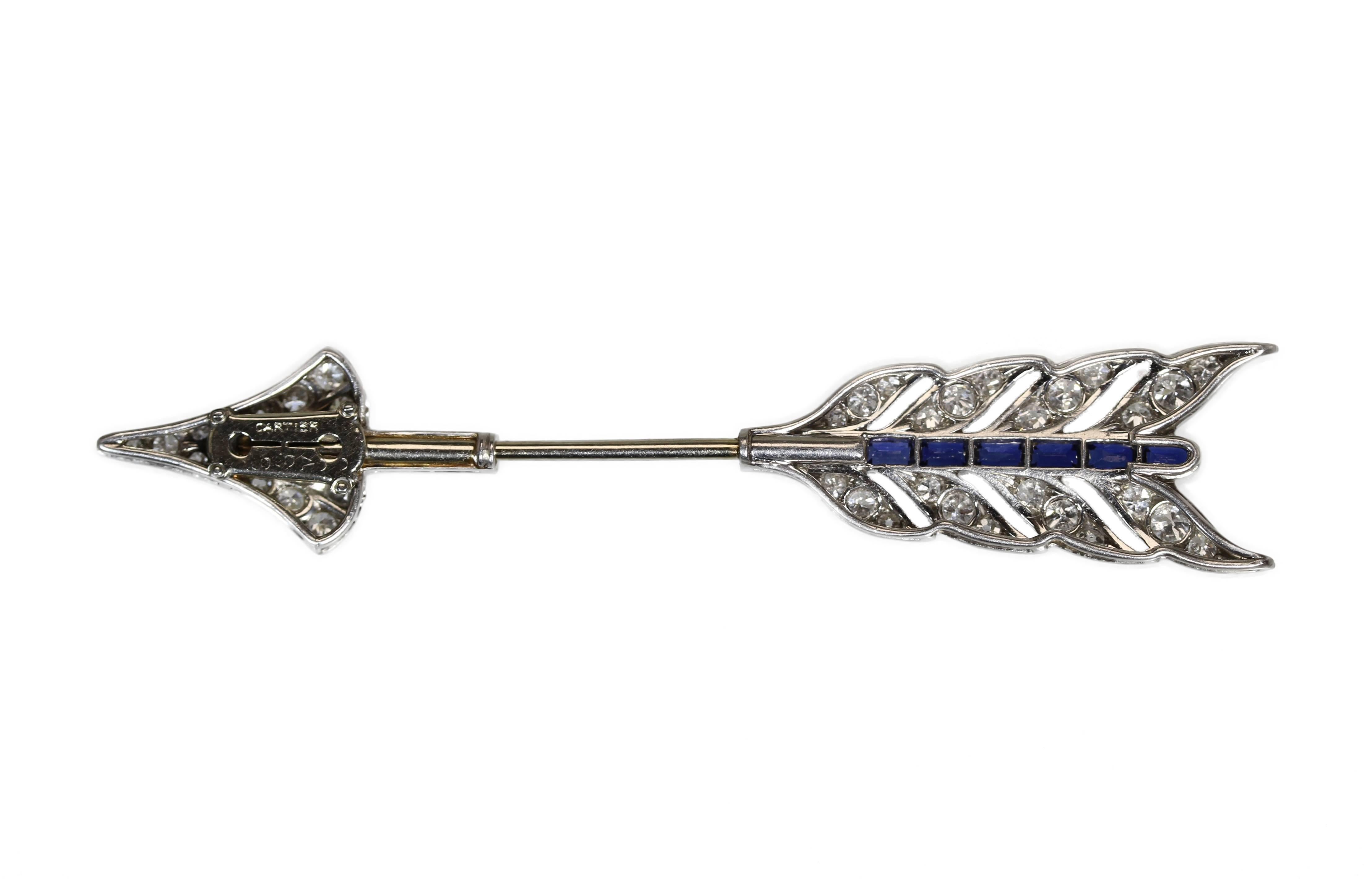 An Art Deco platinum, sapphire and diamond jabot brooch by Cartier, designed as an arrow set with 18 old European-cut diamonds weighing approximately 0.75 carat, and 24 single-cut diamonds weighing approximately 0.50 carat, accented by by 11
