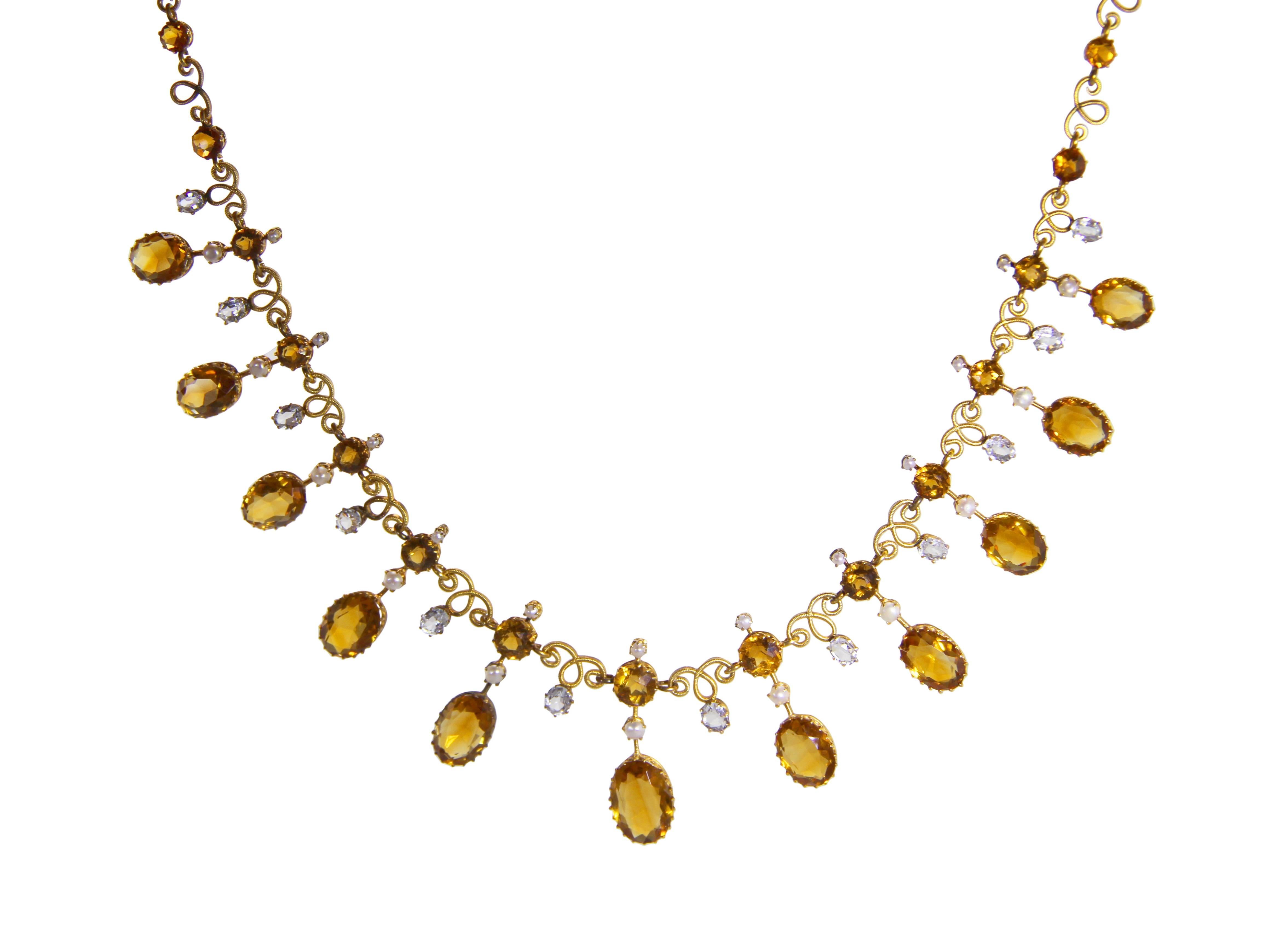 An antique 14 karat gold, citrine quartz, white sapphire and seed pearl necklace, the necklace set with 27 round citrines weighing approximately 9.00 carats, suspending 12 oval citrines of graduating size weighing approximately 20.00 carats,