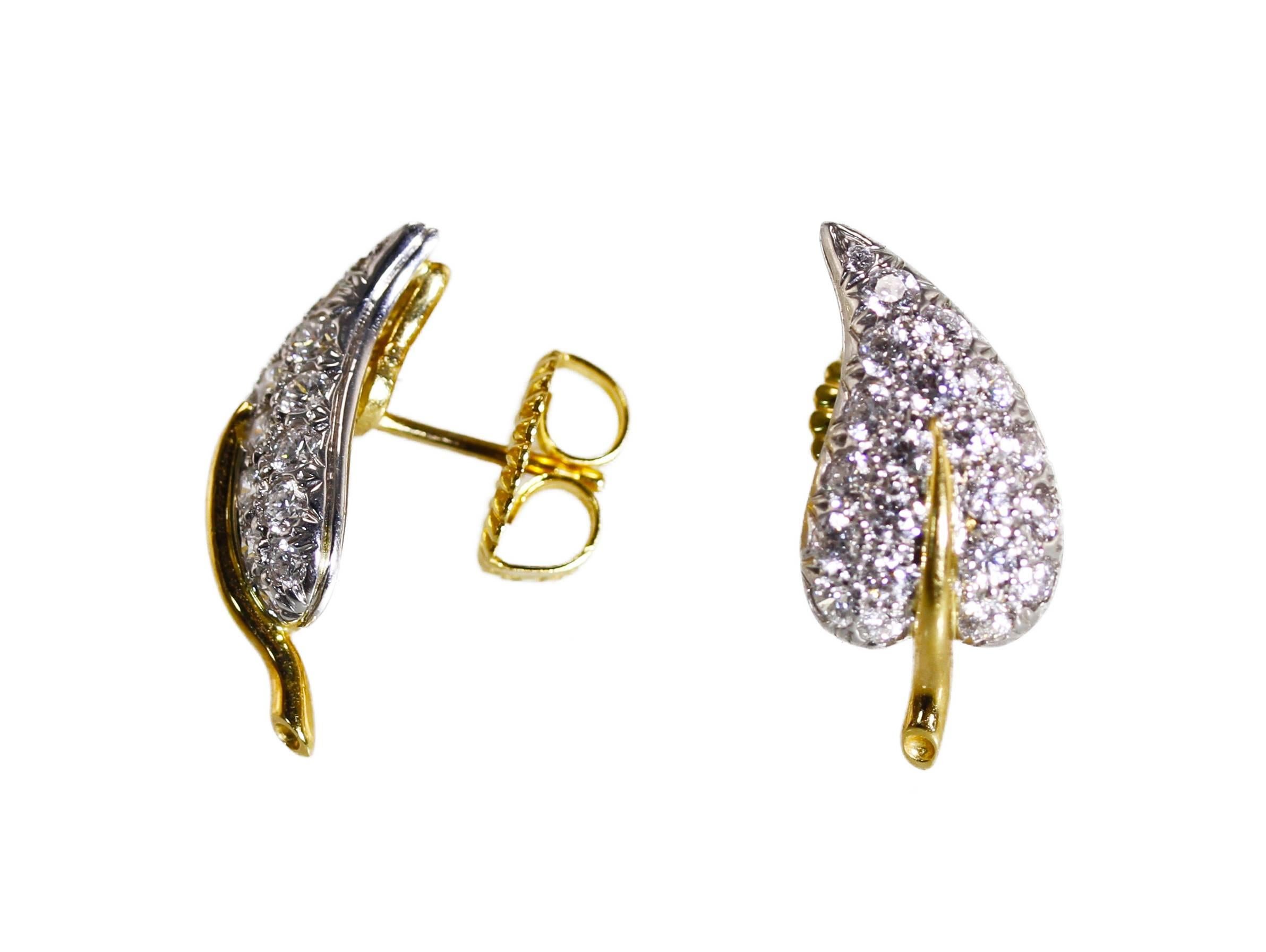 Pair of platinum, 18 karat gold and diamond earrings by Schlumberger for Tiffany & Co., each designed as a slightly curved leaf, set with 42 round diamonds weighing approximately 1.50 carats, measuring 3/4 by 3/8 inch, gross weight 7.0 grams, signed