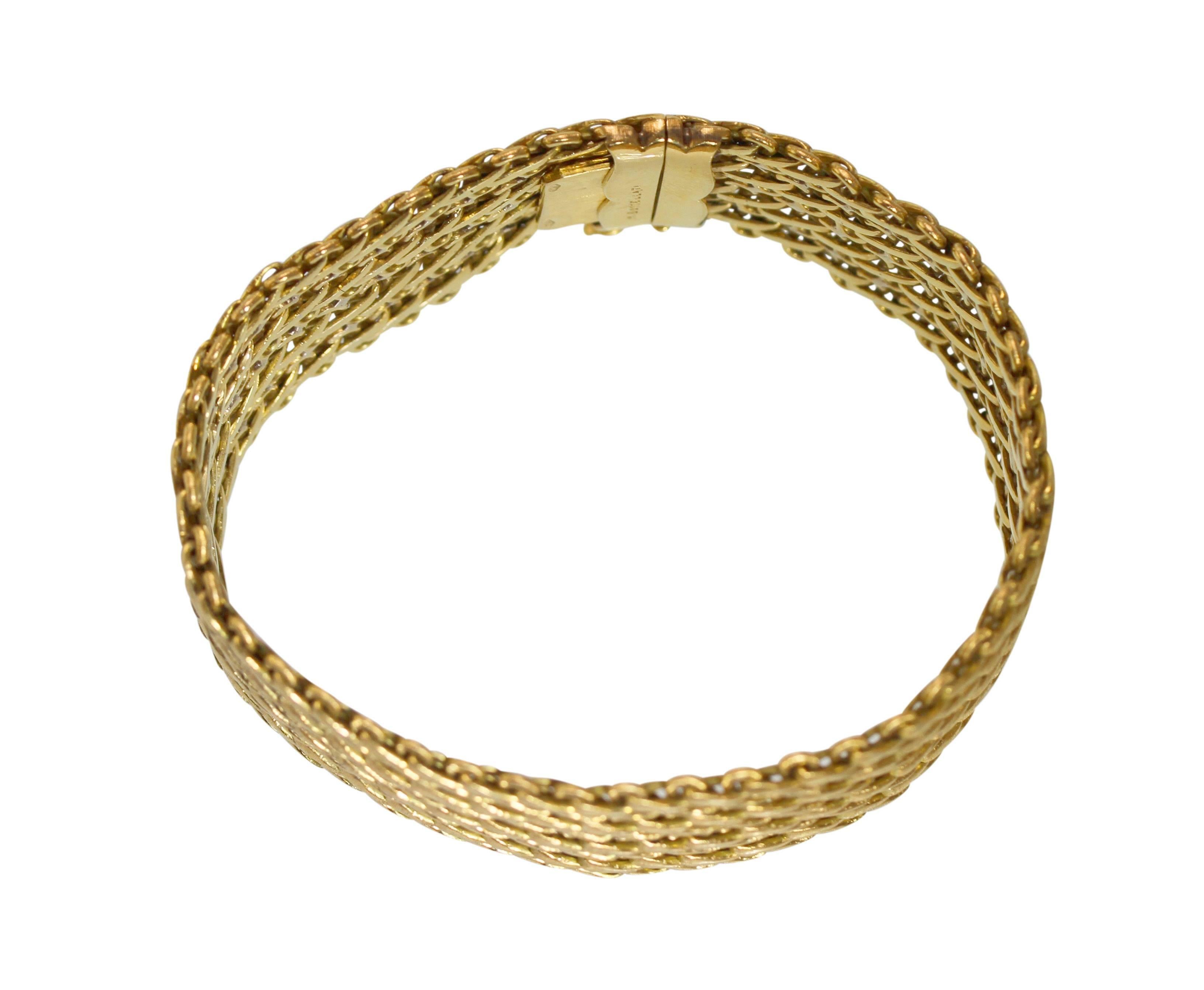 An 18 karat yellow gold by Buccellati, Italy, circa 1970, the wide articulated strap composed of numerous small gold links, gross weight 64.4 grams, length 7 1/4 inches, width 1 inch, signed M. Buccellati, Italian gold marks.