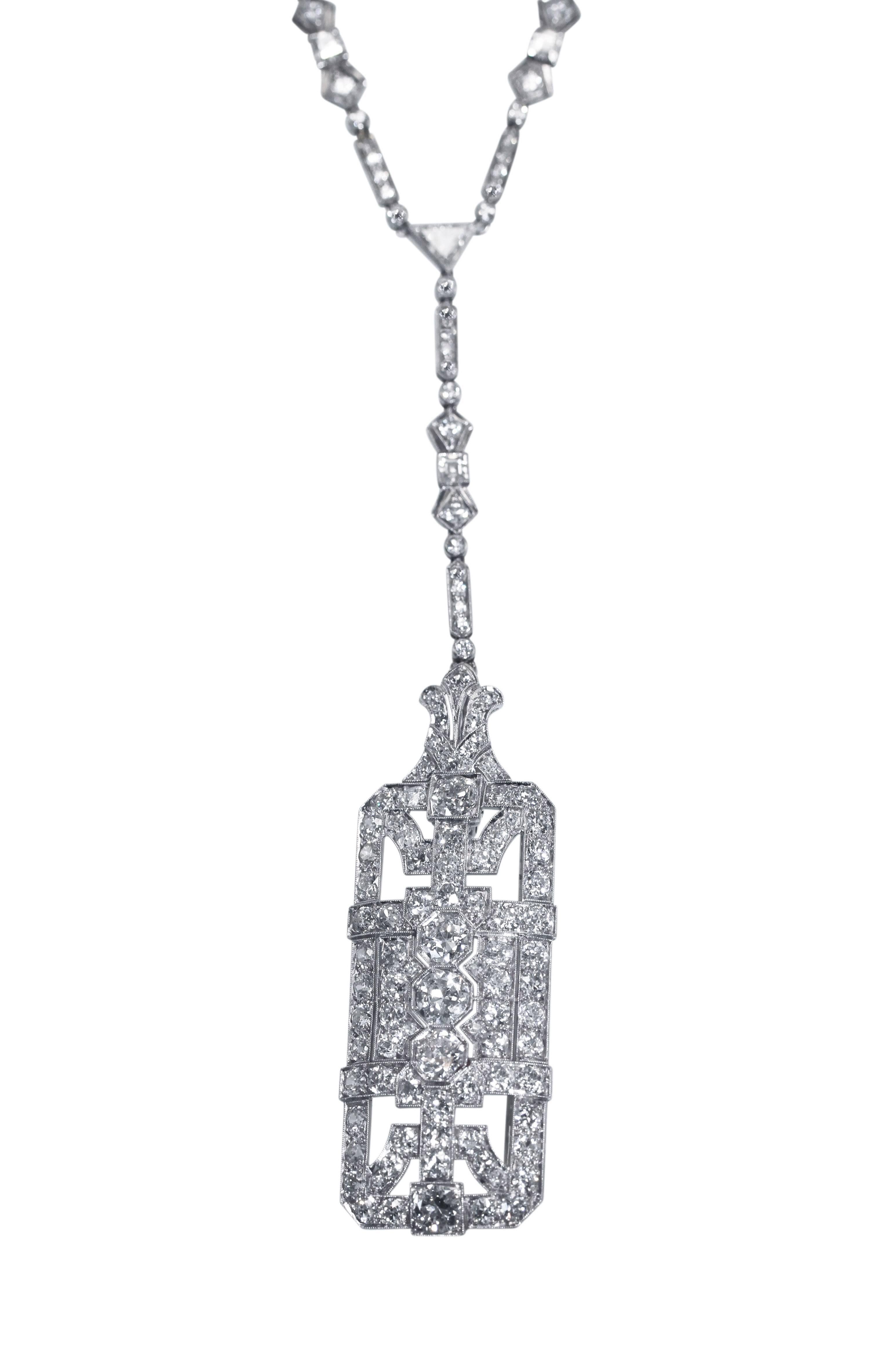 An Art Deco platinum and diamond convertible necklace and brooch/pendant sautoir, circa 1920, designed as a longchain comprised of a series of geometric links suspending a detachable rectangular openwork plaque that converts into a brooch, the chain