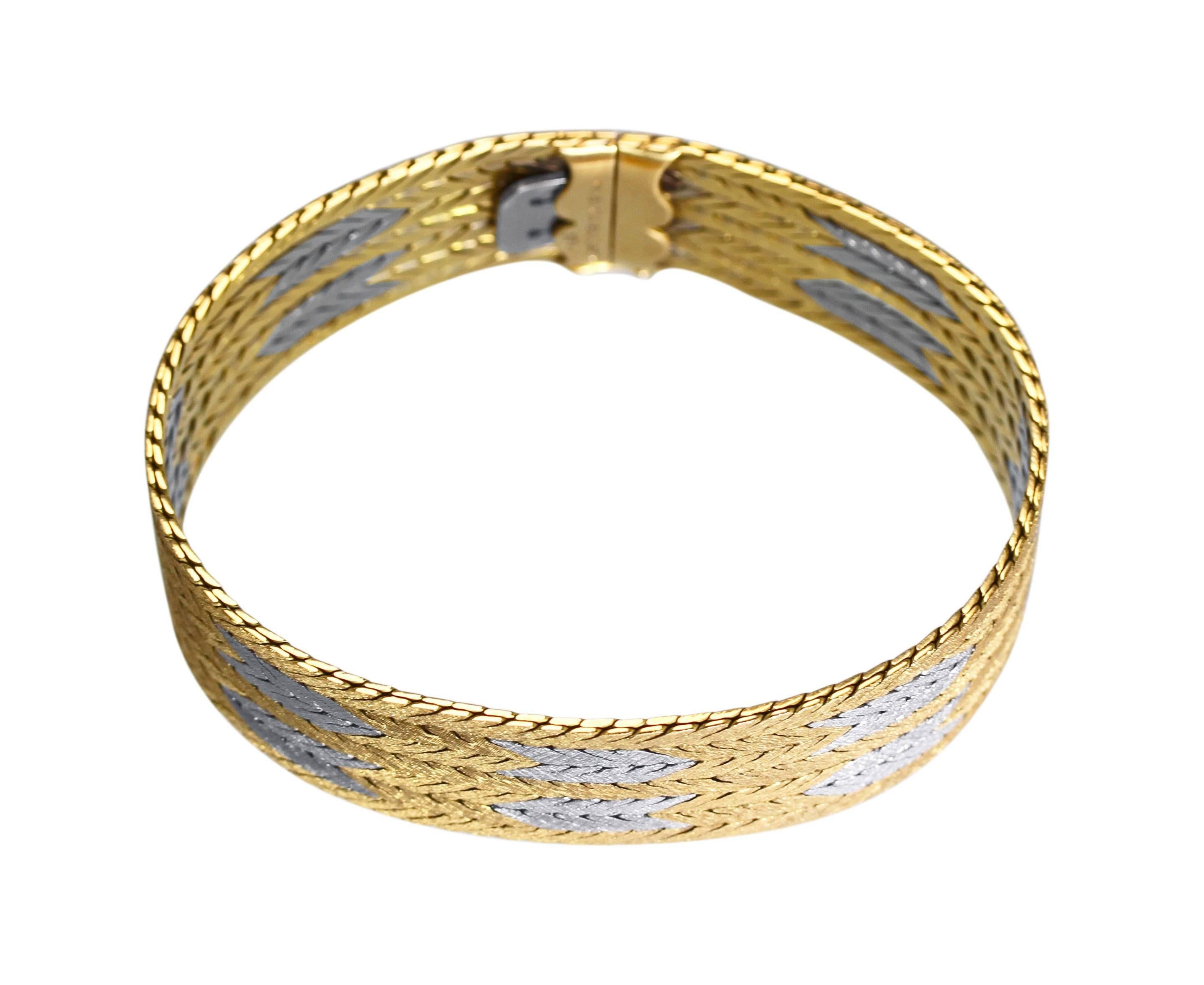 An 18 karat white and yellow gold bracelet by Buccellati, Italy, designed as seven woven strands, length 7 1/2 inches, width 3/4 inch, gross weight of 58.3 grams, and signed M. Buccellati , 18K. 