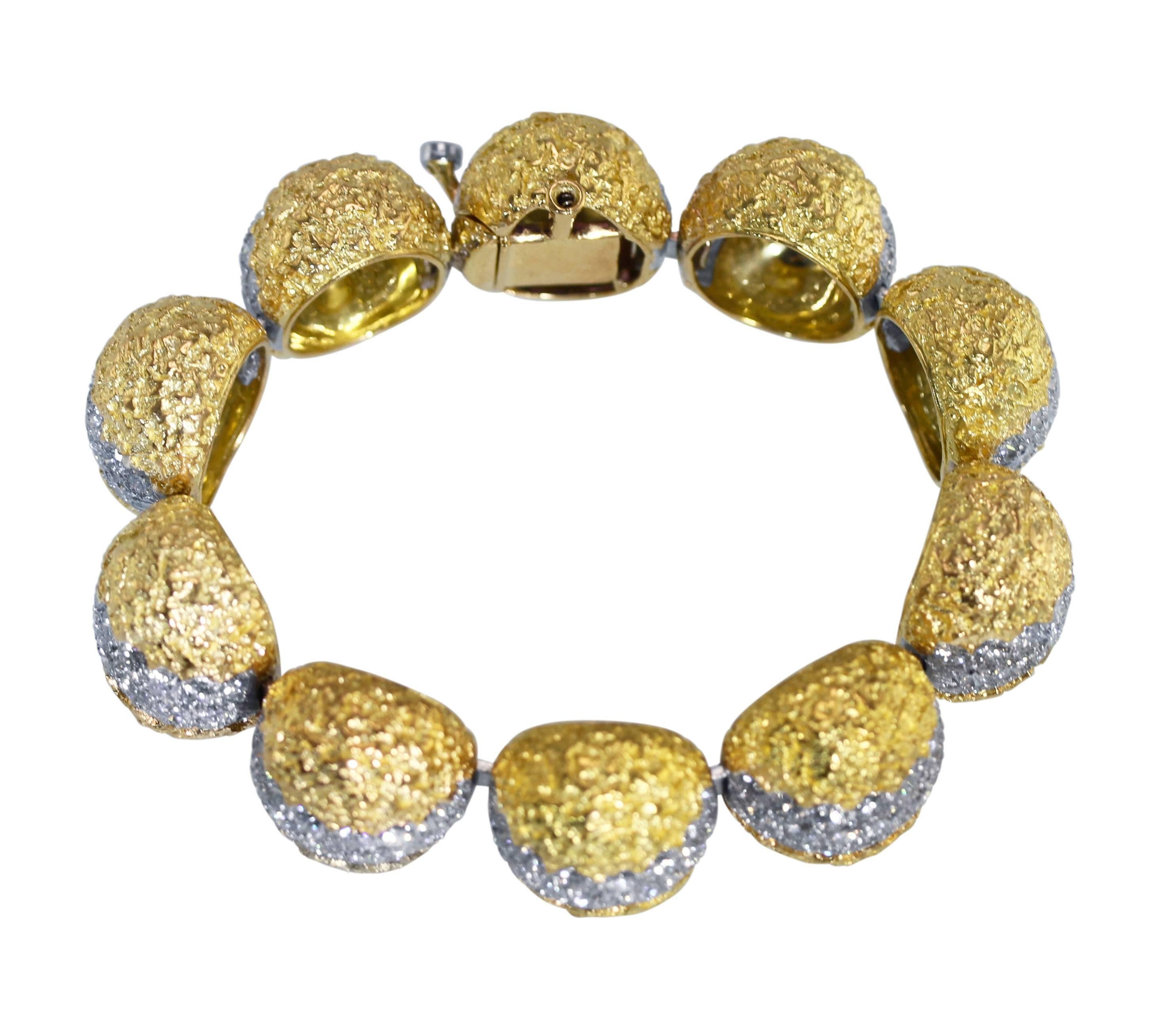 An 18 karat yellow gold, platinum and diamond bracelet by Cartier, France, circa 1970, comprised of ten dome links, set with 228 round diamonds weighing approximately 20.00 carats, length 7 inches, width 3/4 inch, gross weight 83.3 grams, signed