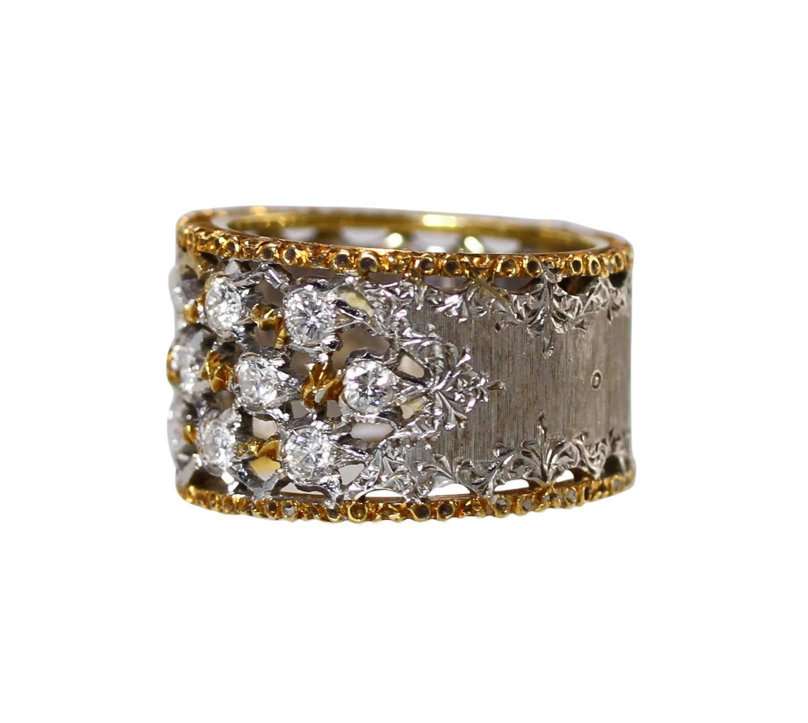An 18 karat white and yellow gold and diamond ring by Buccellati, Italy, the slightly tapered band with an openwork section at the front set with 13 round diamonds weighing approximately 0.75 carat, measuring 3/4 by 3/4 inch, tapering in width from