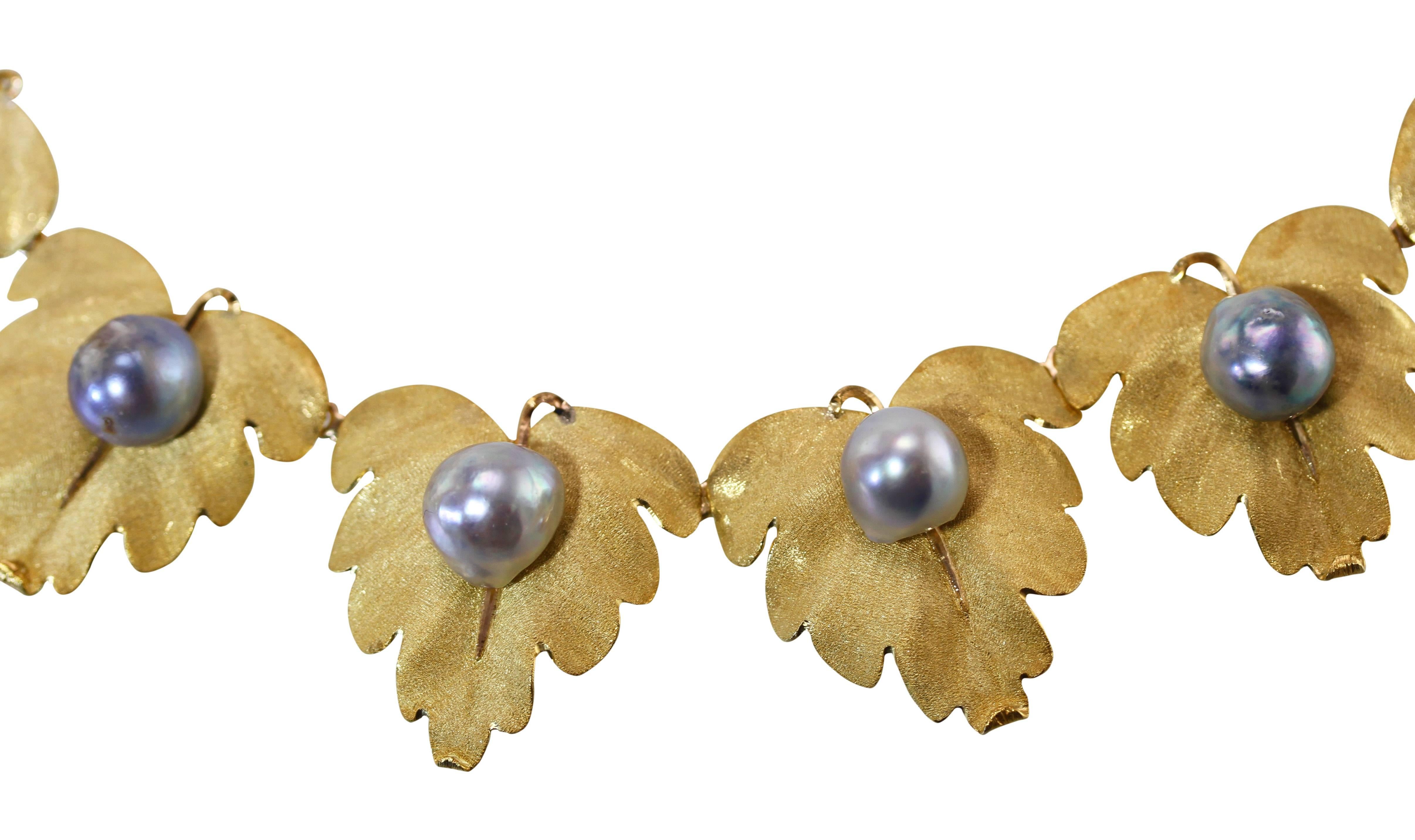 An 18 karat yellow gold and cultured pearl necklace by Buccellati, Italy, designed as sixteen textured gold leaves each set with a baroque cultured pearl, length 18 1/2 inches, width 1 1/8 inches, gross weight 117.7 grams, signed Buccellati, stamped
