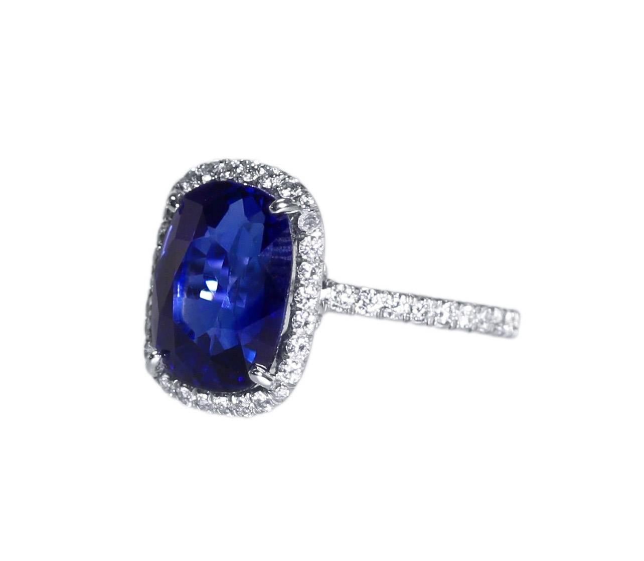 A platinum, sapphire and diamond ring, set in the center with a cushion-shaped sapphire weighing 7.84 carats, framed and flanked by 92 round diamonds weighing approximately 1.15 carats, measuring 1/2 by 3/4 by 1 inch, gross weight 5.4 grams, finger