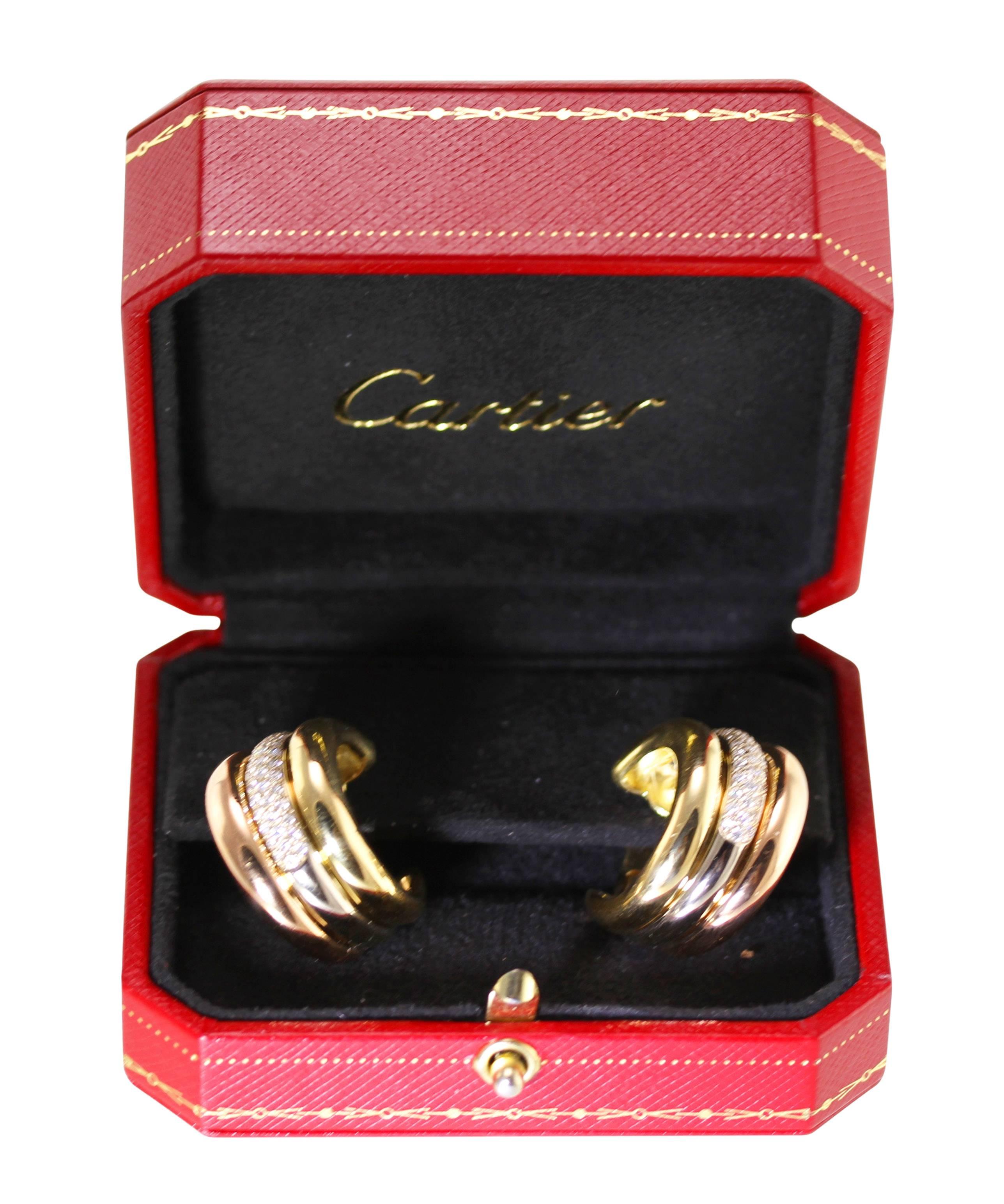 Pair of 18 karat tri-tone gold and diamond earclips by Cartier, circa 1995
• Signed Cartier, numbered D38169, stamped CARTIER C 1995
• 88 round diamonds approximately 1.25 carats
• Gross weight 34.7 grams, measuring 1 by 1/2 by 1 inch