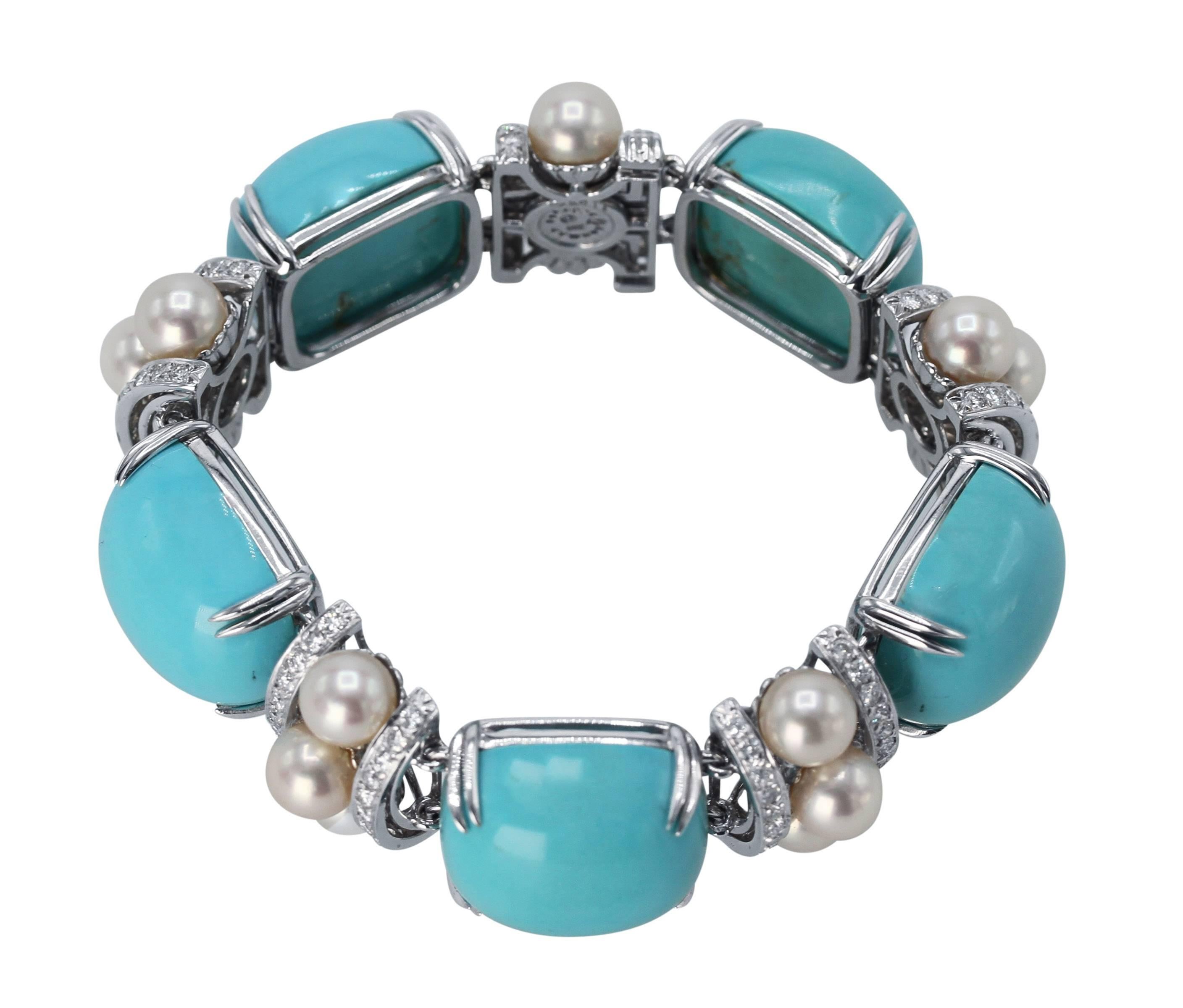 An 18 karat white gold, turquoise, cultured pearl and diamond bracelet by Seaman Schepps, set with 5 modified square-shaped cabochon turquoise measuring approximately 20.3 by 17.9 by 10.6 mm., spaced by curved links set with 108 round diamonds