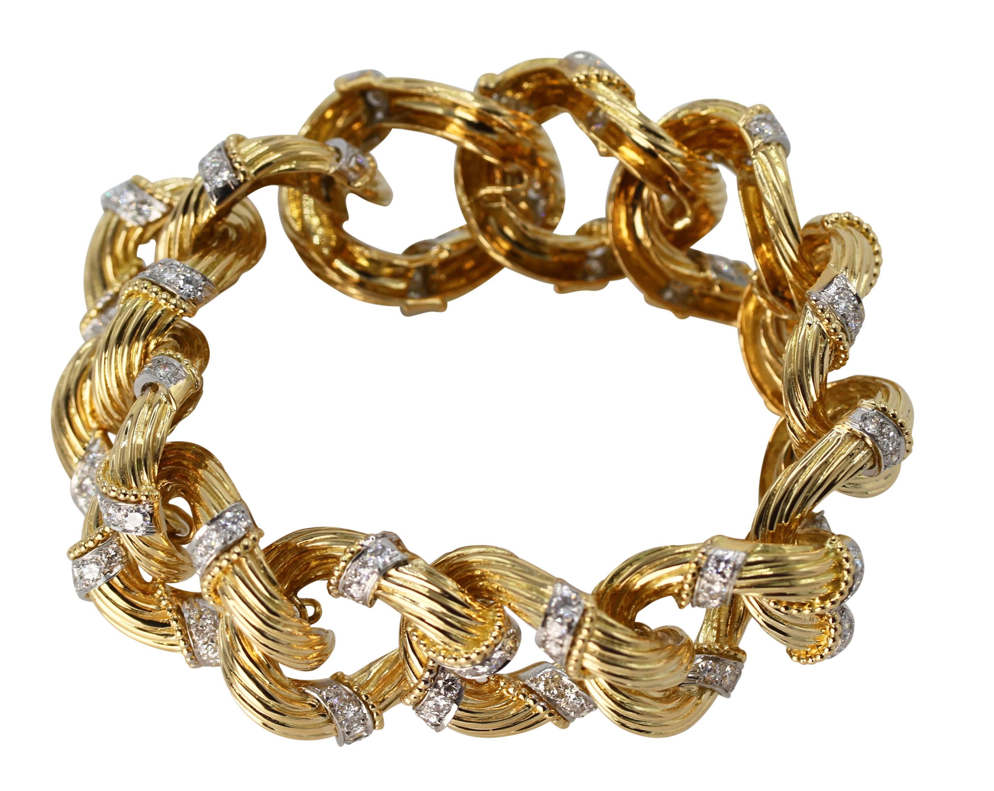 An 18 karat yellow gold, platinum and diamond bracelet by Van Cleef & Arpels, circa 1960, designed as twelve ribbed interlocking curb links accented by 180 round diamonds weighing approximately 10.00 carats, length 8 inches, width 1 inch, gross