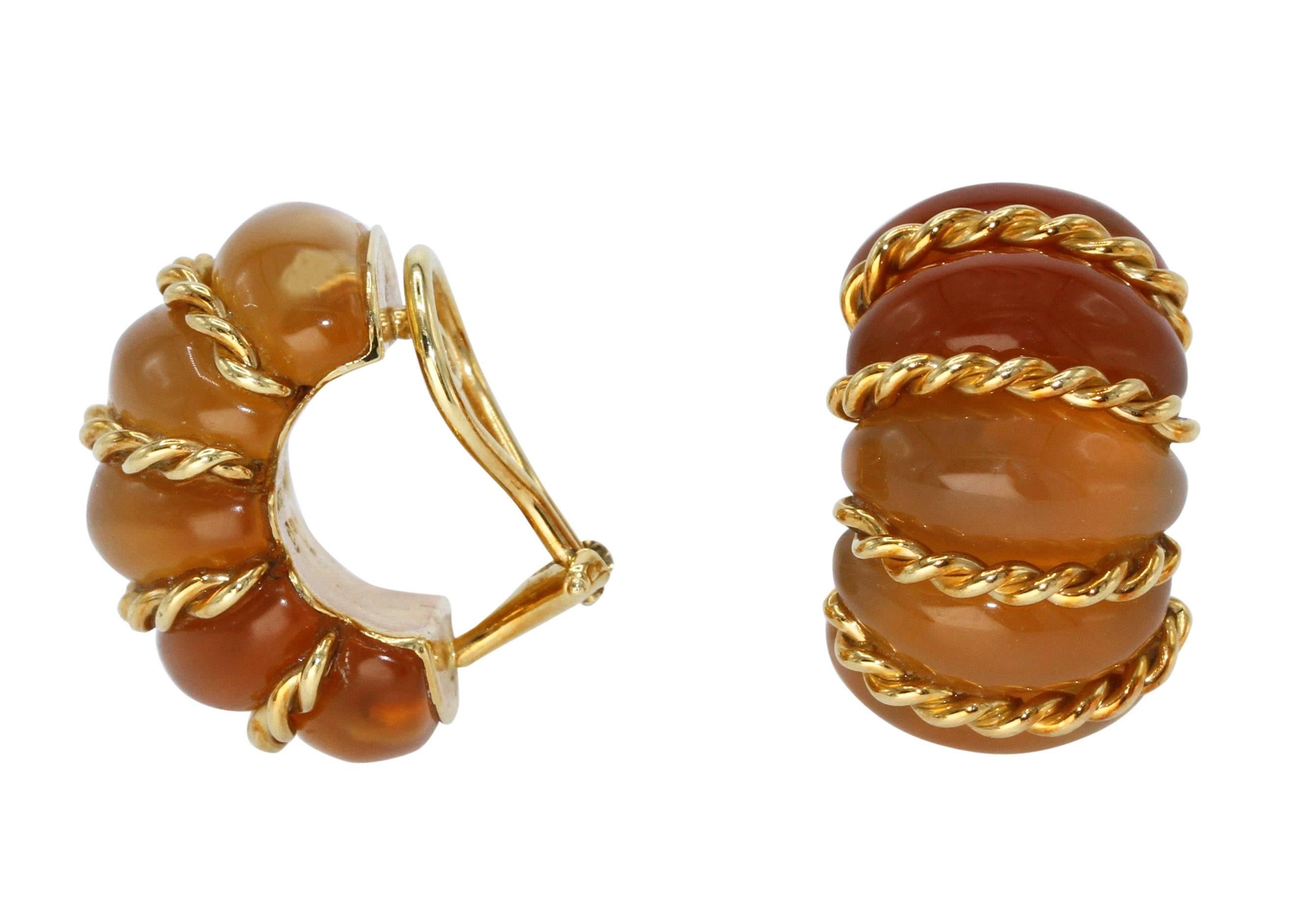 A pair of 18 karat yellow gold and citrine earclips by Seaman Schepps, designed as half hoops of curved cabochon citrine sections divided by gold ropetwist bands, gross weight 21.2 grams, measuring 1 by 3/4 by 5/8 inches, signed Seaman Schepps,