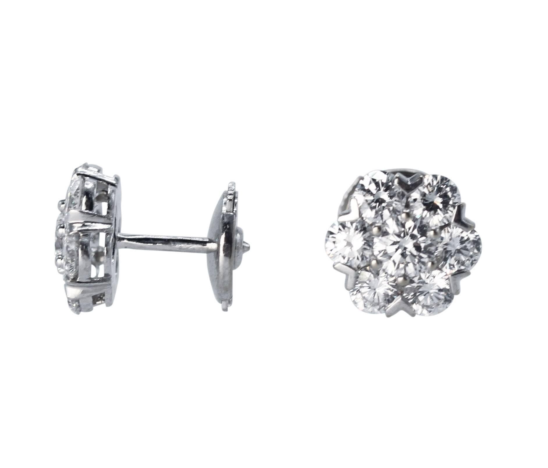 Pair of 18 Karat White Gold and Diamond 'Fleurette' Earrings by Van Cleef & Arpels
• Signed VCA, numbered BL49935, stamped OR and 750 
• 14 round diamonds weighing 1.82 carats
• Gross weight 3.2 grams, measuring 3/8 by 3/8 inch
• Known retail $25,700