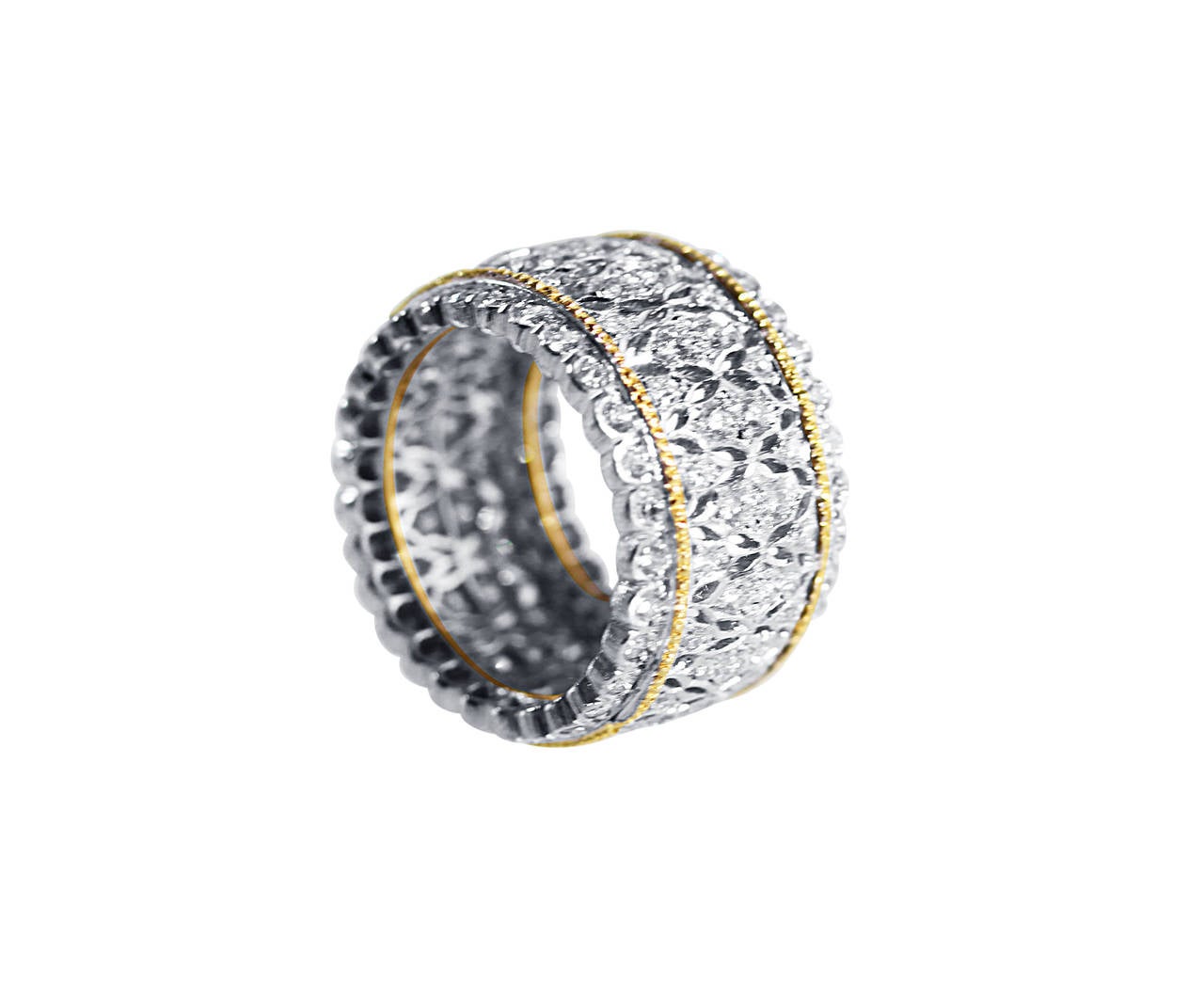 An 18 karat white and yellow gold and diamond band ring by Buccellati, Italy, the wide band of openwork tulle design set throughout with 126 round diamonds weighing approximately 2.85 carats, gross weight 11.1 grams, size 6 1/4, measuring 7/8 by 1/2