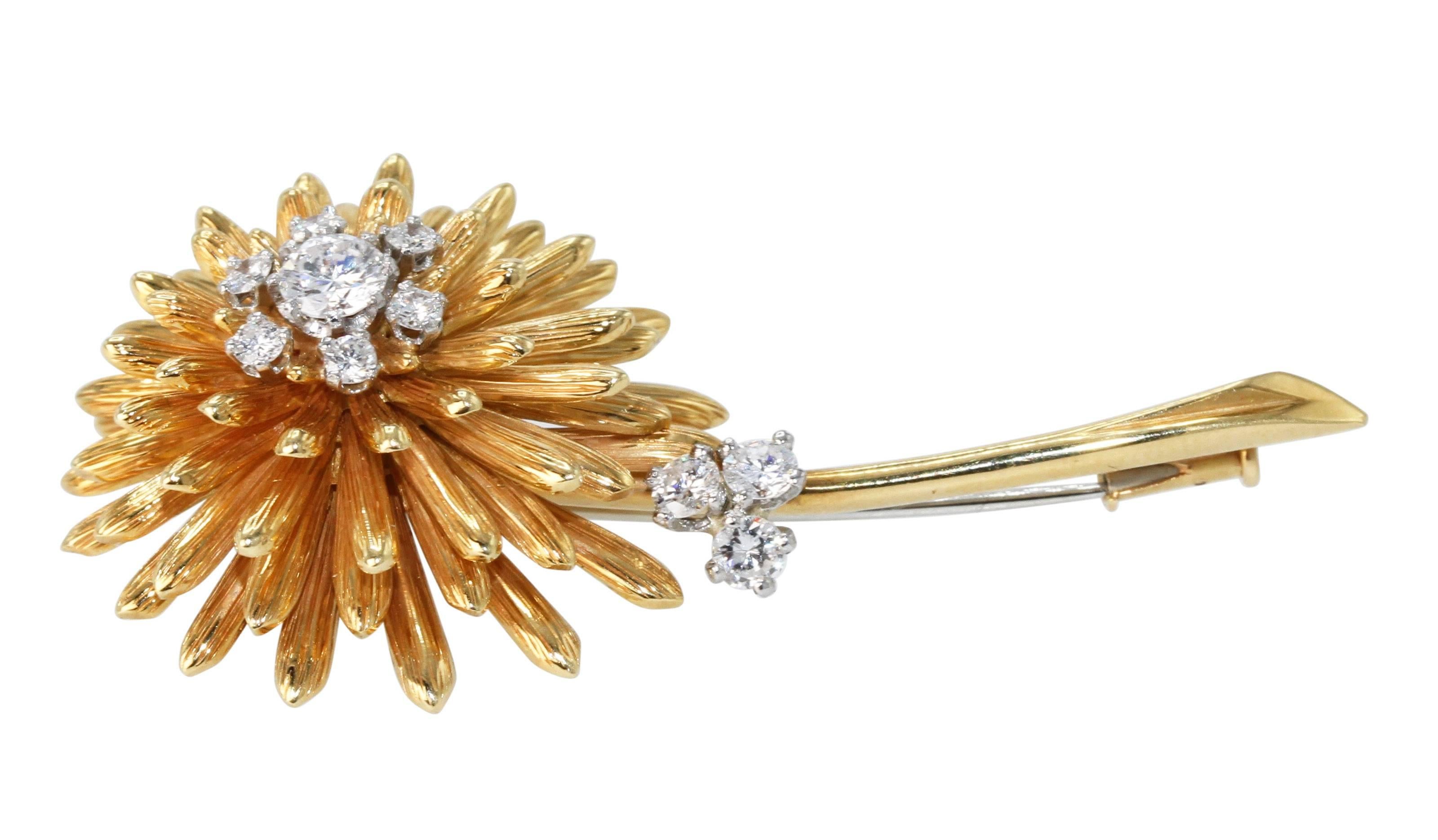 18 Karat Gold and Diamond Flower Brooch by Cartier, circa 1970
• Signed Cartier, numbered L9081
• 10 round diamonds weighing approximately 0.75 carat
• Gross weight 19.3 grams, measuring 2 by 1 inches