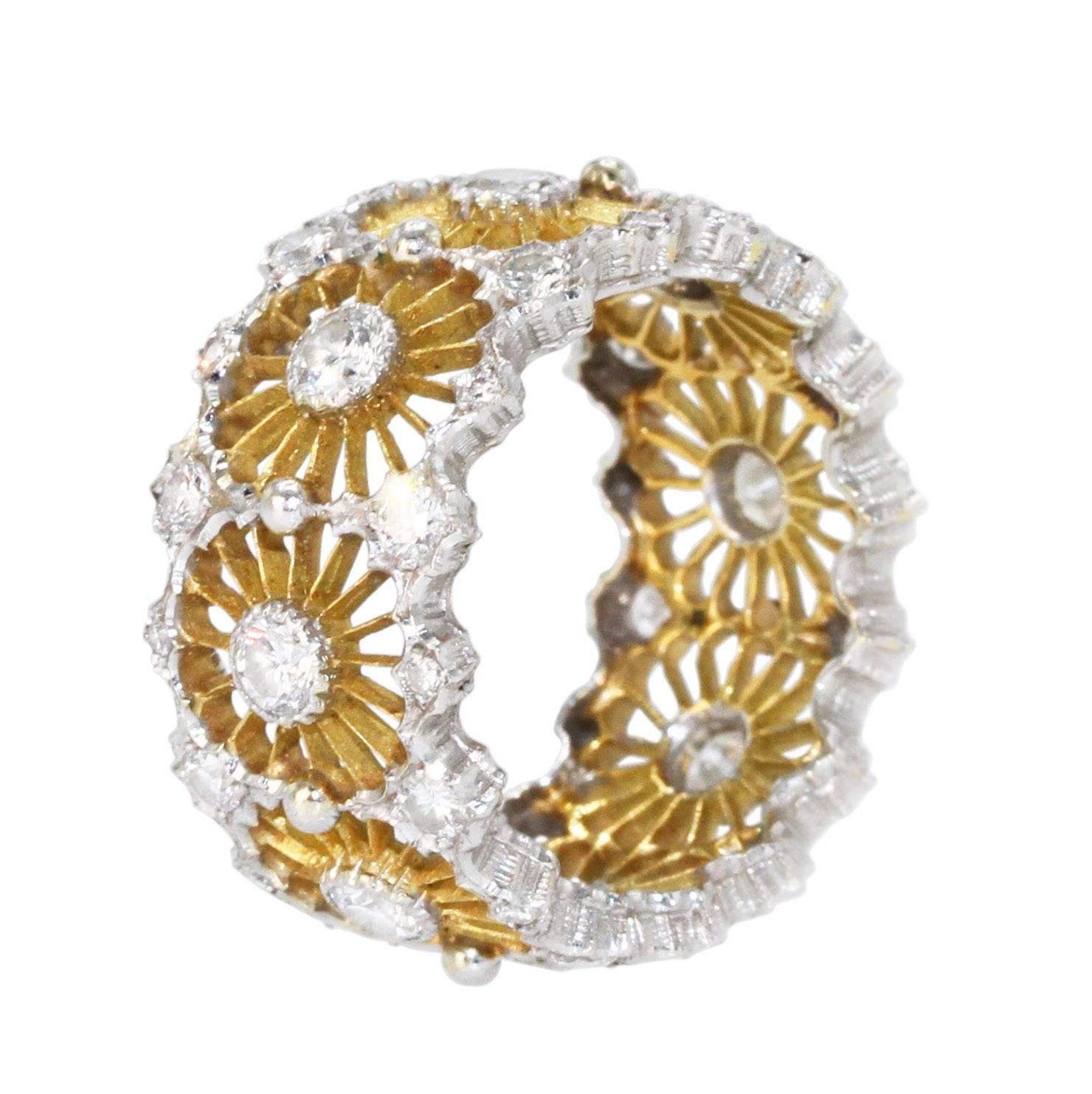 An 18 karat white and yellow gold and diamond band ring by Buccellati, Italy, of openwork design set with 40 round diamonds weighing approximately 1.50 carats, gross weight 6.0 grams, size 6, signed Buccellati, Italy.                        