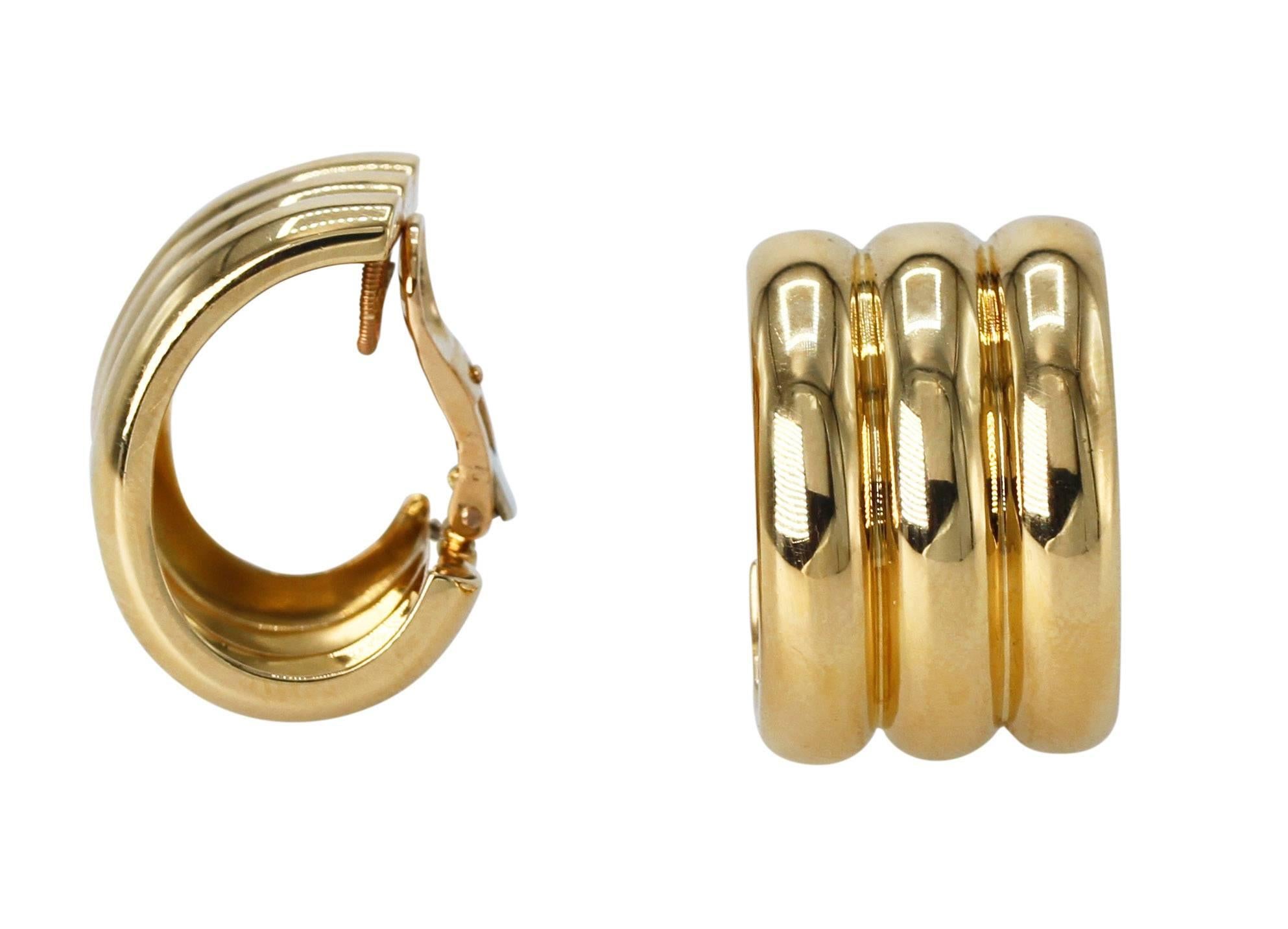 Pair of 18 Karat Yellow Gold Hoop Earclips by Cartier, France
• Signed Cartier, numbered 641248 
• French assay marks and makers marks
• 18 karat yellow gold, gross weight 27.9 grams
• Measuring 1 by 5/8 inch