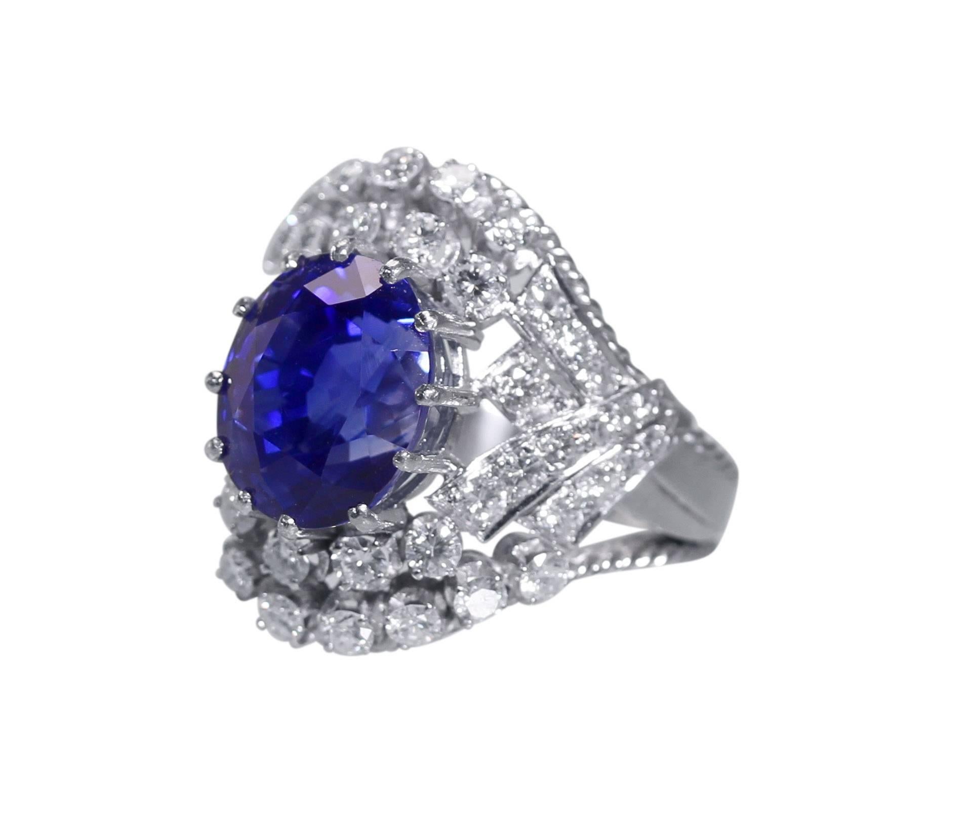 Platinum, Sapphire and Diamond Ring, circa 1950
• Oval sapphire weighing 12.00 carats
• Accompanied by recent AGL report stating that the sapphire is natural unheated from Sri Lanka (Ceylon)
• 48 round diamonds approximately 2.00 carats
• Size 7
