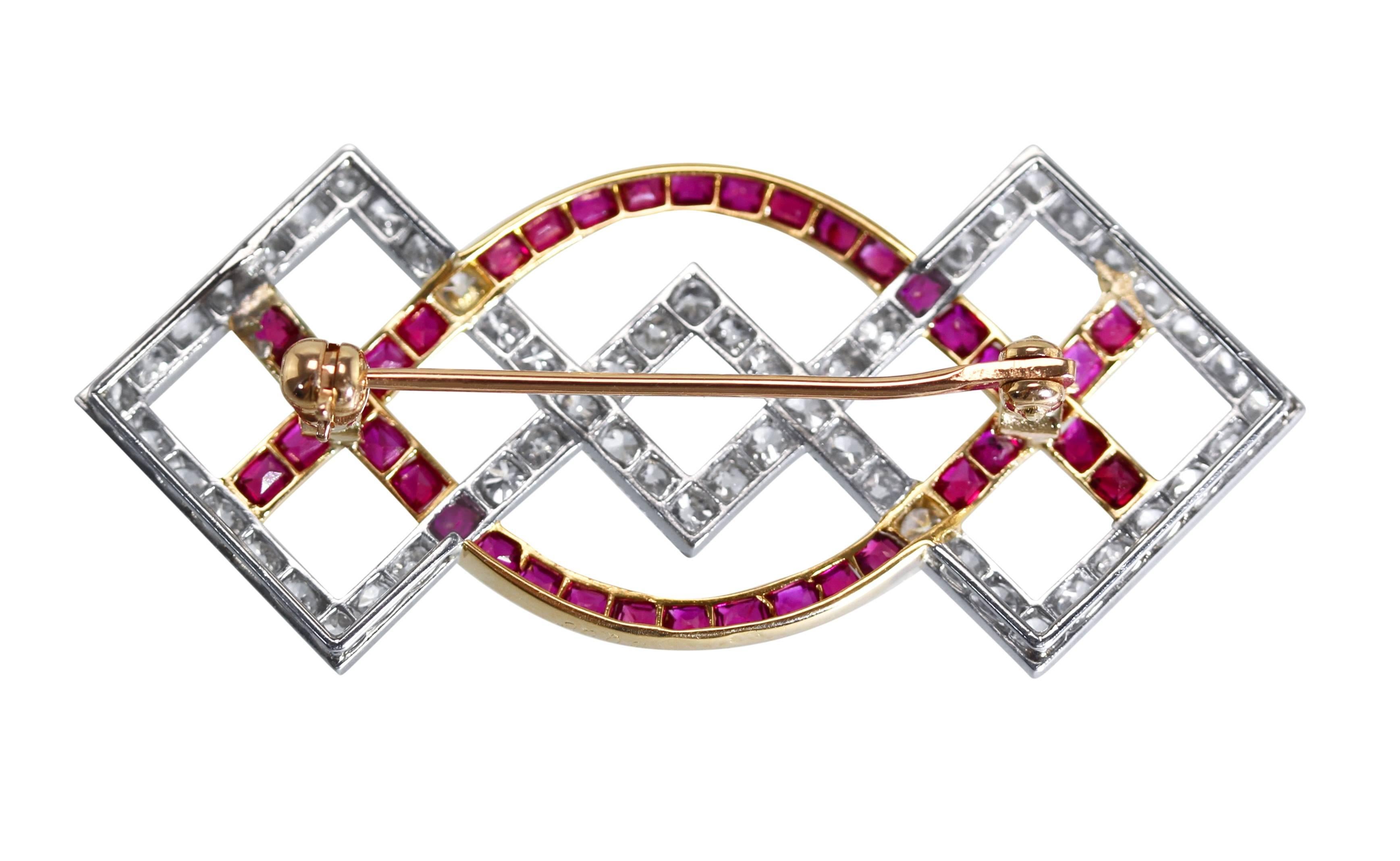 Art Deco Platinum, 18 Karat Gold, Ruby and Diamond Brooch by Cartier, Paris
• Signed Cartier Paris, numbered 2006, with French assay marks
• 57 old European-cut diamonds weighing approximately 1.25 carats
• 38 mixed-cut rubies weighing approximately