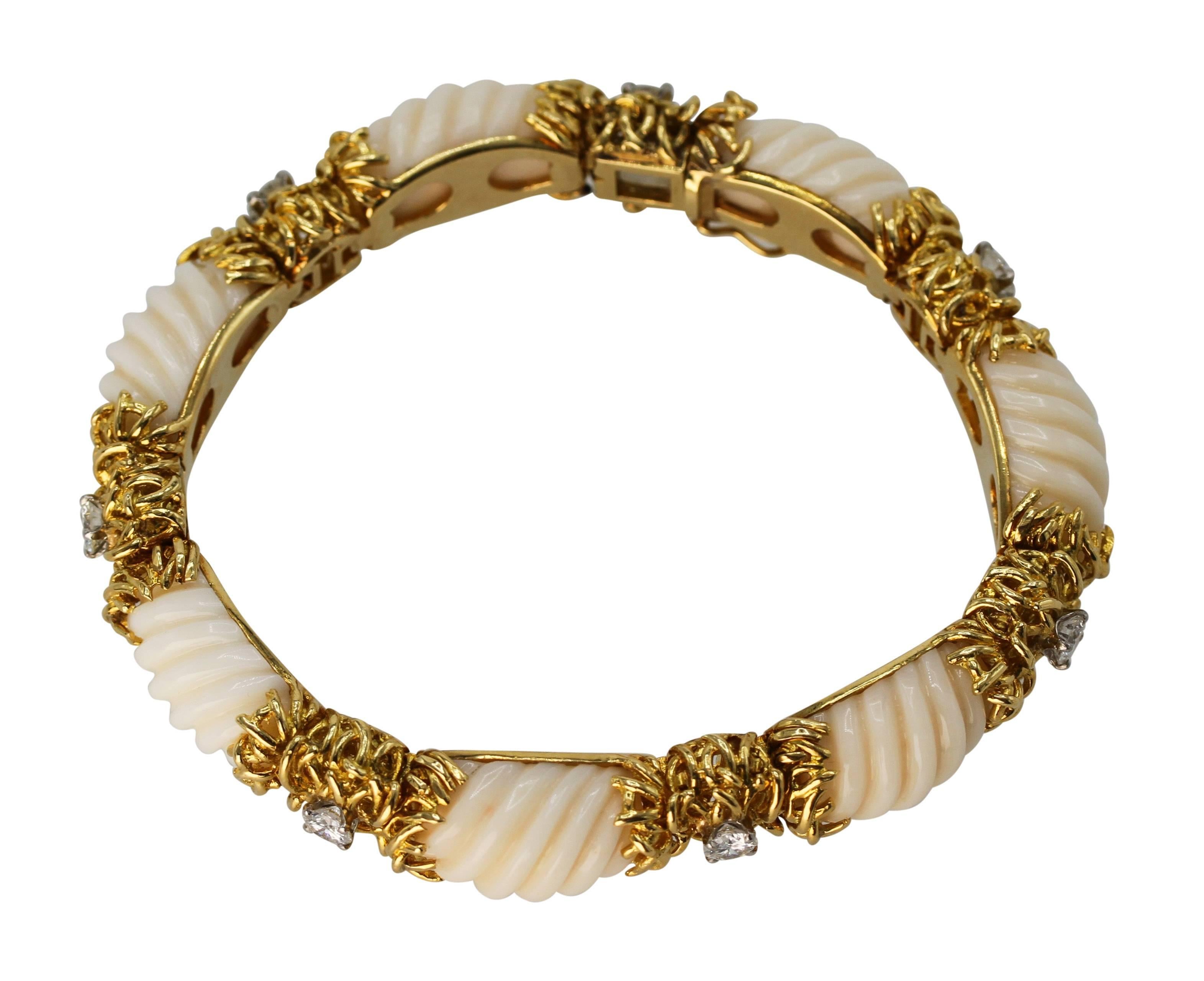 18 Karat Gold, Fluted Coral and Diamond Bracelet, circa 1970
• Stamped 18K
• Seven fluted coral sections
• 7 round diamonds approximately 2.00 carats
• Length 7 inches, width 3/8 inch, gross weight 67.0 grams