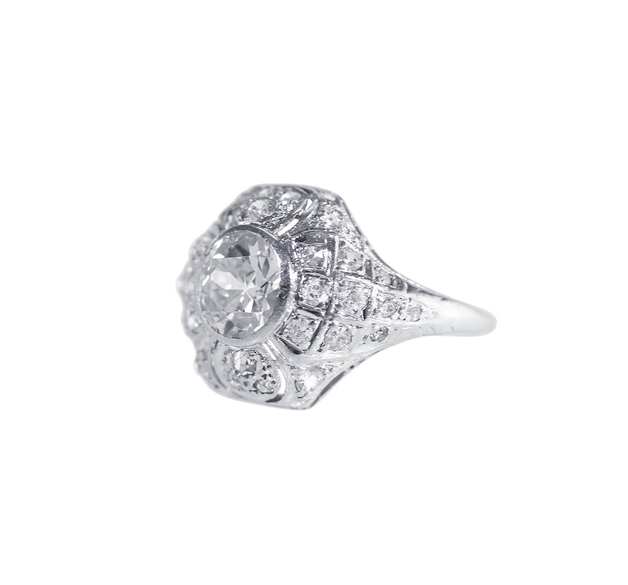 An Art Deco platinum and diamond ring, set in the center with an old European-cut diamond weighing approximately 1.15 carats, within a domed framed set with 30 smaller old European-cut diamonds weighing approximately 0.60 carat, gross weight 3.8