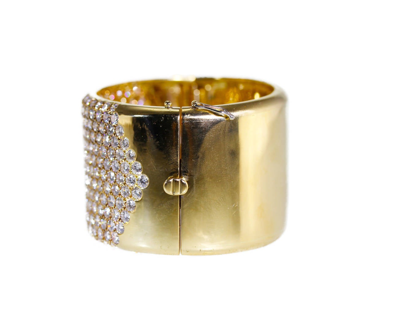 An 18 karat yellow gold cuff bracelet, the wide polished gold cuff set at the front with 257 round diamonds of excellent quality and match weighing approximately 36.00 carats, gross weight 104.7 grams, length 6 3/4 inches, width 1 3/8 inches,